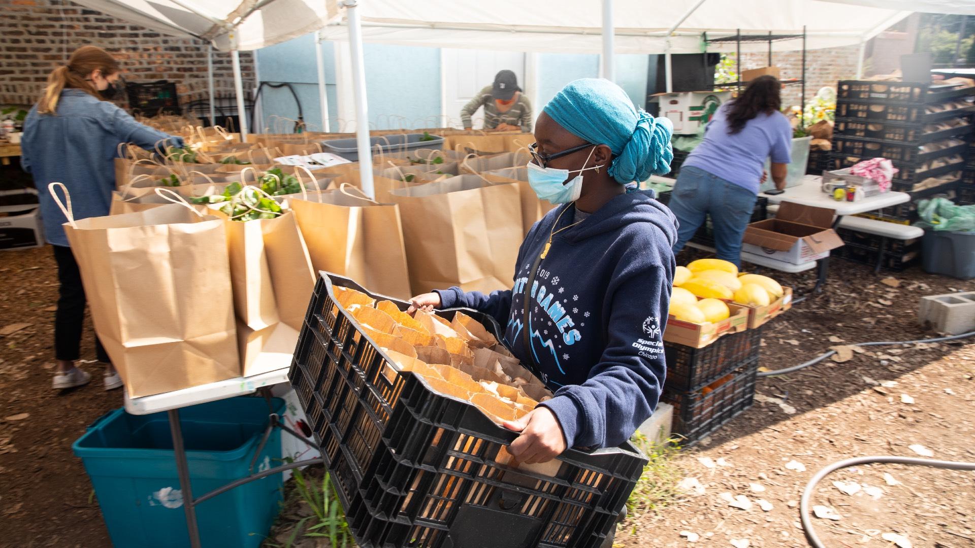 Volunteers at Star Farm pack bags of fresh produce, purchased from small farms, to be delivered for free to South Side residents through the Market Box program. (Davon Clark)