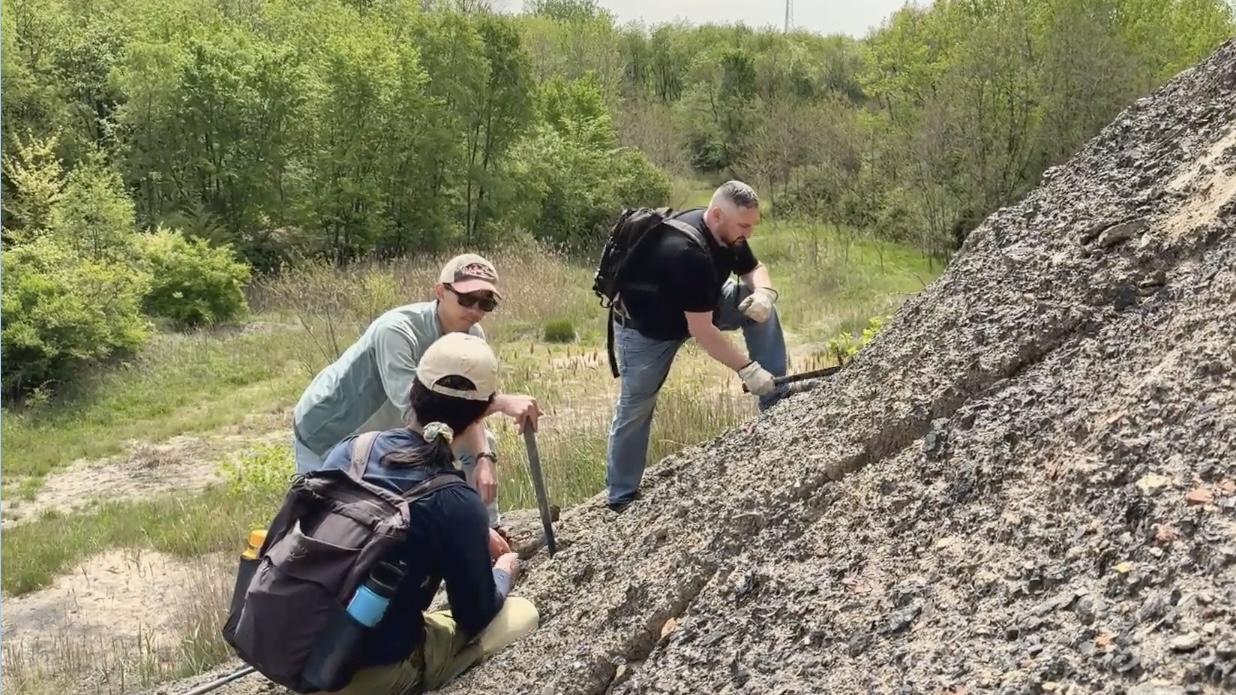 Jeremy Zimmerman (right) joined a Field Museum expedition to a Mazon Creek site in spring 2025. Fossils of 300-million-year-old plants and other organisms are buried in spoil piles left over from coal mining operations. (Courtesy of the Field Museum)