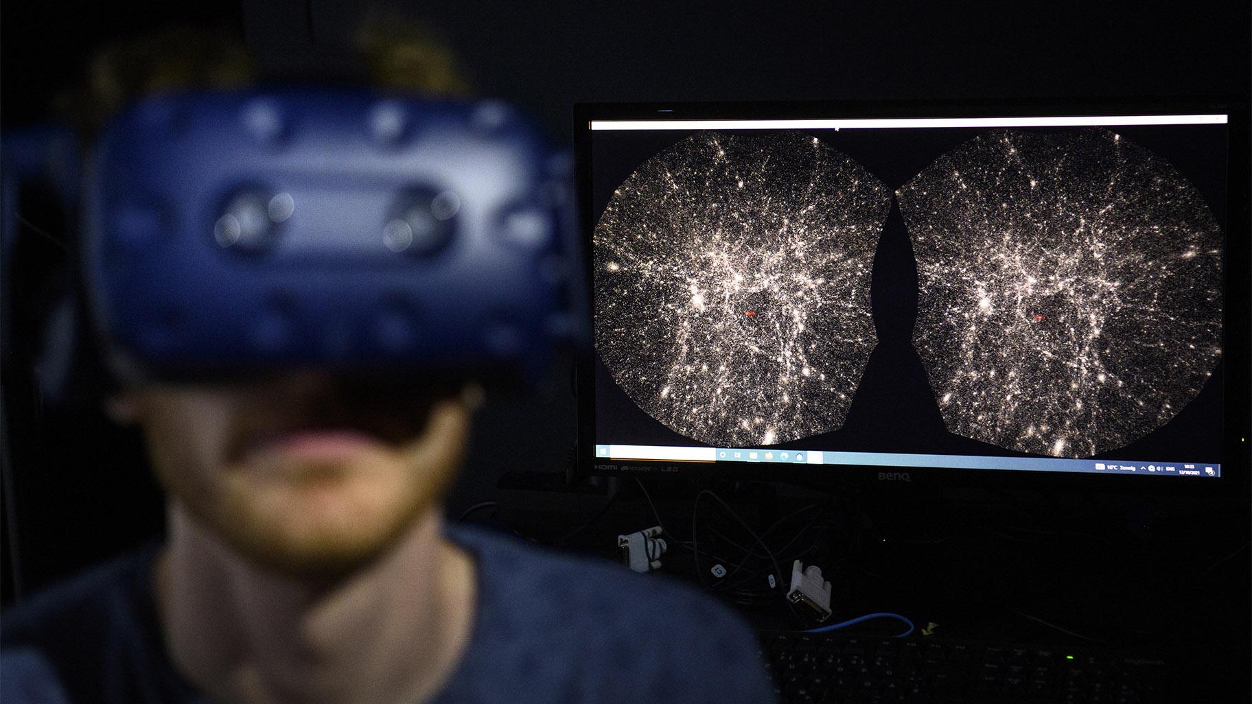 FILE - In this Oct. 12, 2021 file photo, Hadrien Gurnel, software engineer EPFL's Laboratory for Experimental Museology (eM+) explores with a virtual reality helmet the most detailed 3D map of the universe with the virtual reality software VIRUP, Virtual Reality Universe Project developed by Swiss Federal Institute of Technology, in St-Sulpice near Lausanne, Switzerland. (Laurent Gillieron / Keystone via AP) 