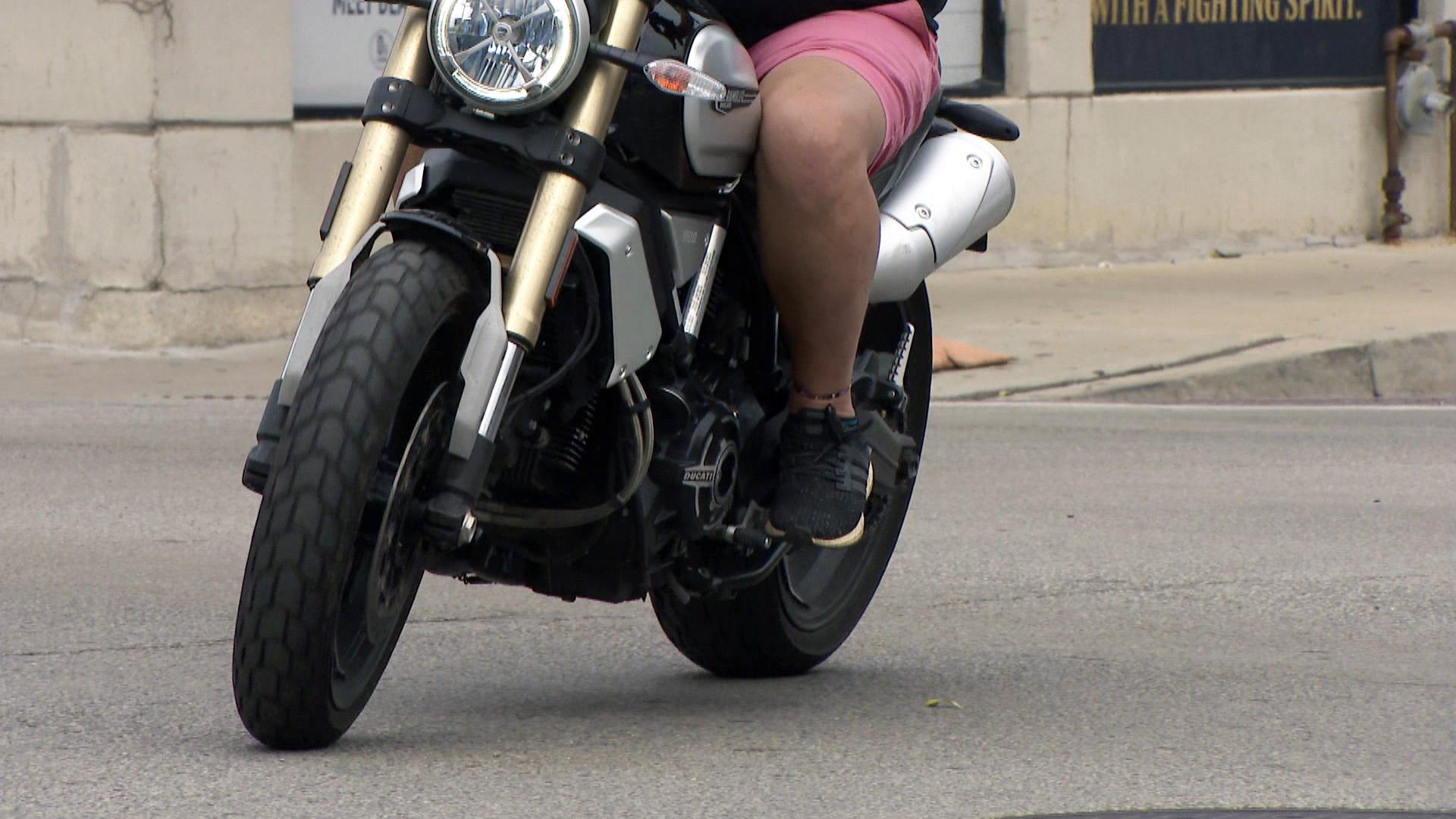 A person rides a motorcycle in Chicago. (WTTW News)