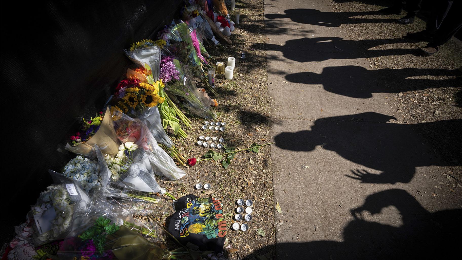 Visitors cast shadows at a memorial to the victims of the Astroworld concert in Houston on Sunday, Nov. 7, 2021. (AP Photo / Robert Bumsted)