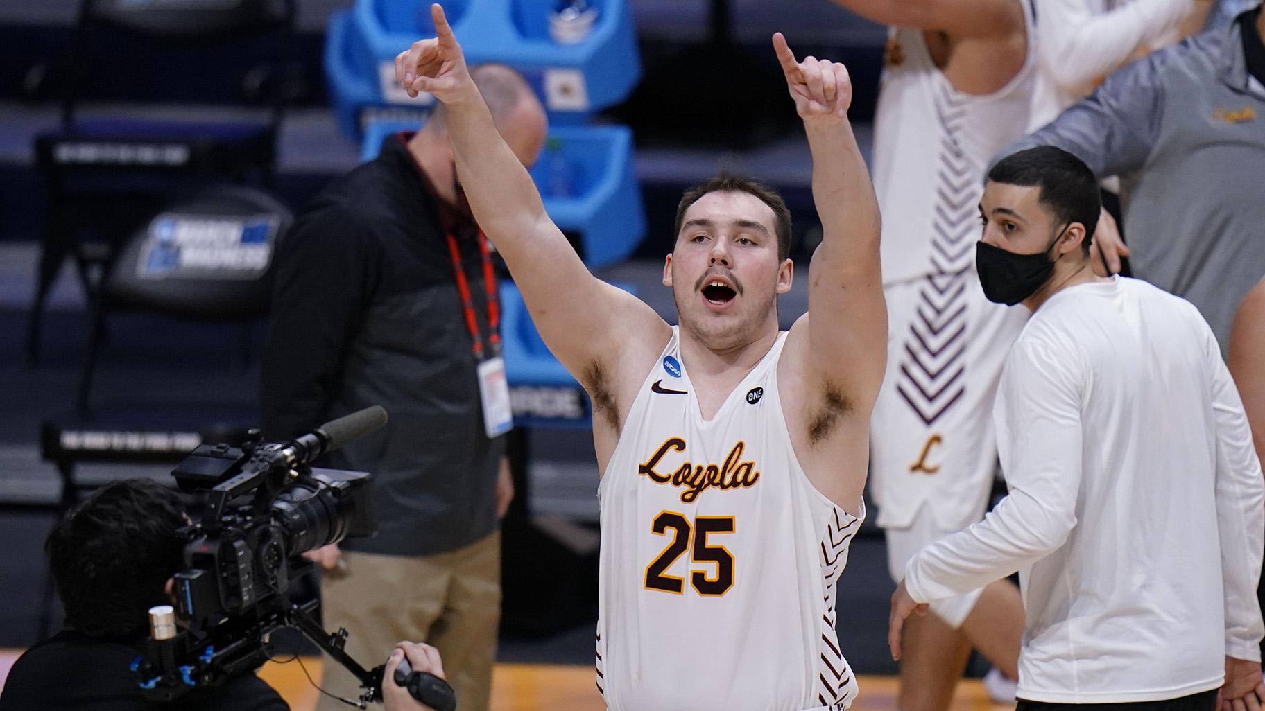 Loyola Chicago center Cameron Krutwig (25) celebrates after defeating Georgia Tech 71-60 in a first-round game in the NCAA men’s college basketball tournament at Hinkle Fieldhouse, Indianapolis, Friday, March 19, 2021. (AP Photo / AJ Mast)