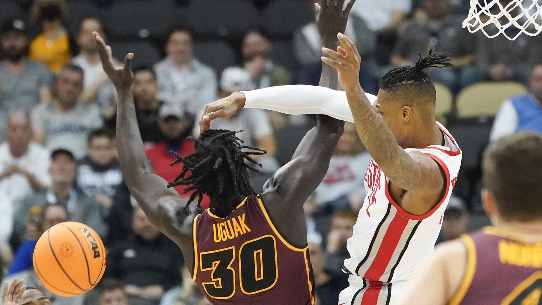 Ohio State’s Eugene Brown III, right, blocks a shot by Loyola of Chicago’s Aher Uguak (30) during the first half of a college basketball game in the first round of the NCAA tournament, Friday, March 18, 2022, in Pittsburgh. (AP Photo / Keith Srakocic)