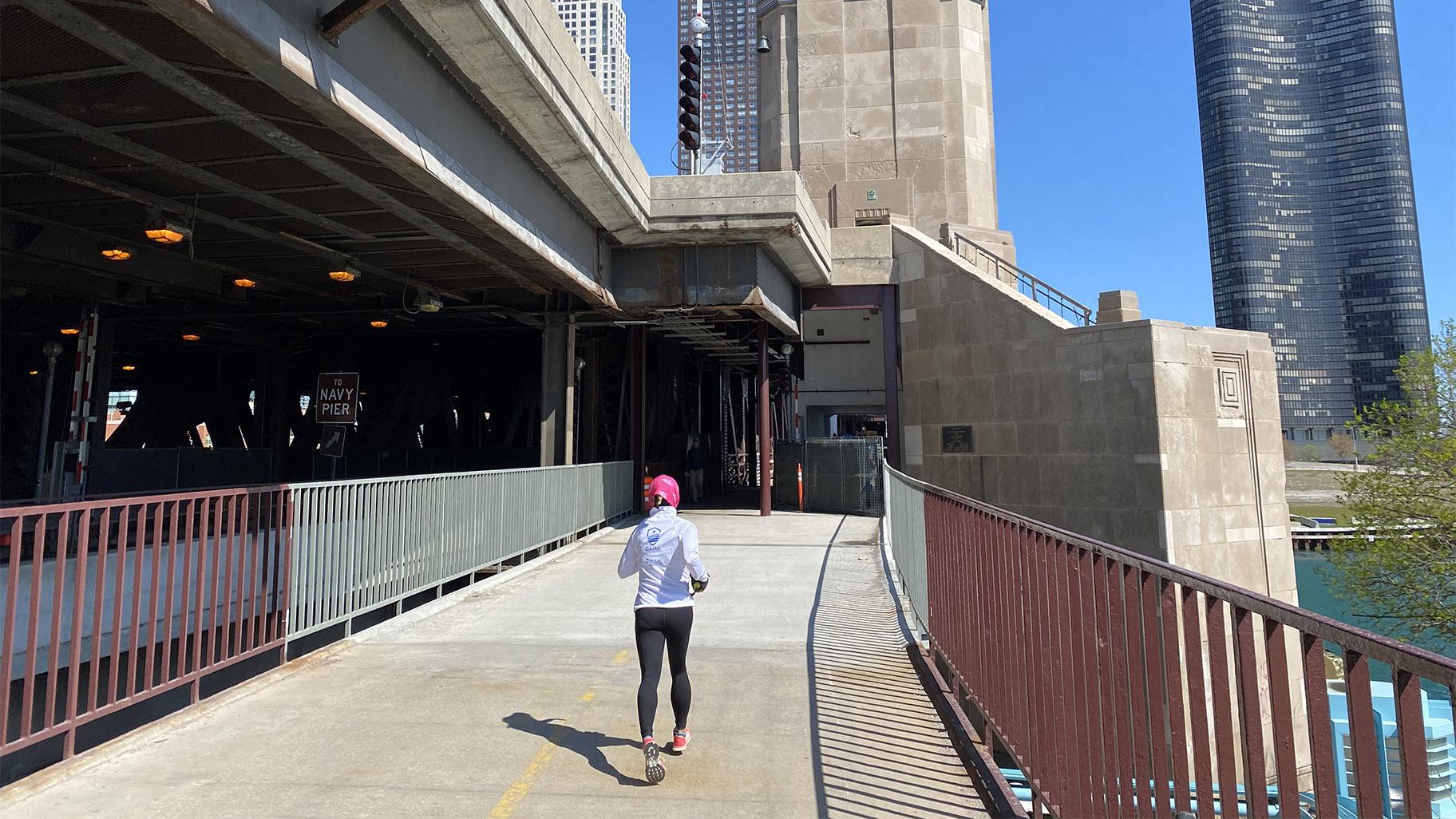 A runner approaches one of the Lake Shore Drive bridge houses on the nearly finished Navy Pier Flyover portion of the lakefront trail, April 30, 2021. (Nick Blumberg / WTTW News)