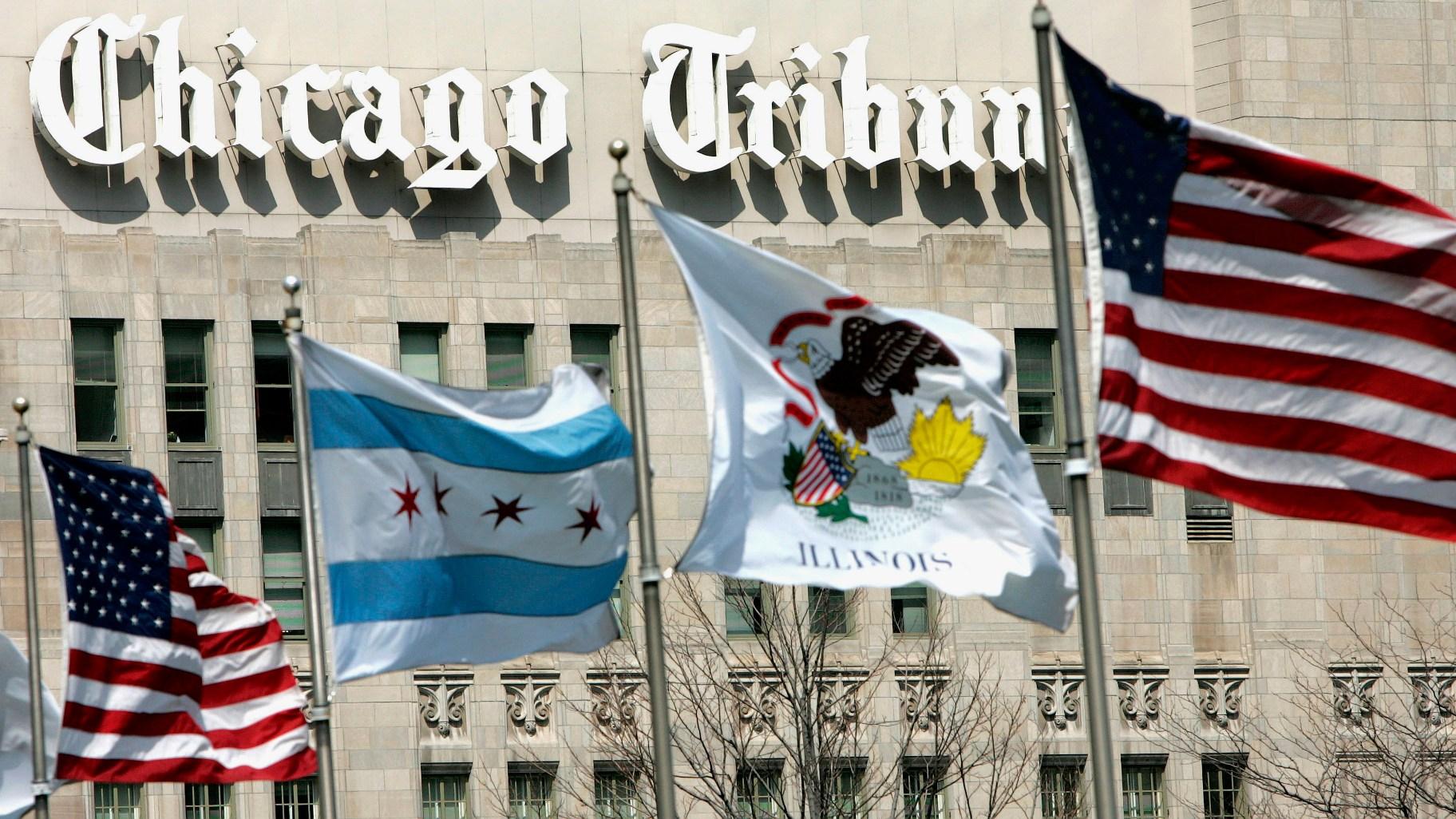 In this April 12, 2006, file photo, flags wave near the Chicago Tribune Tower in downtown Chicago. (AP Photo / Charles Rex Arbogast, File)
