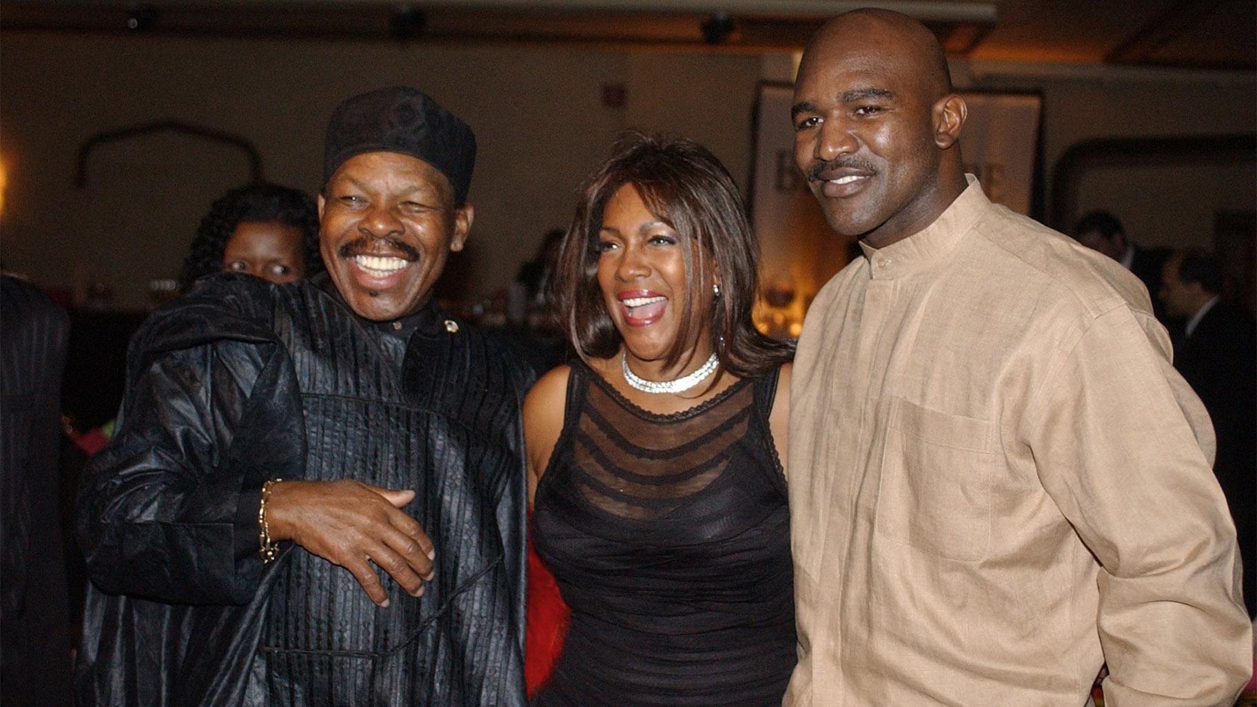 FILE - In this Feb. 20, 2003 file photo, Lloyd Price, left, and Mary Wilson, of the Supremes, pose for a photograph with boxer Evander Holyfield during the reception of the 13th Annual Pioneer Awards presented by the Rhythm & Blues Foundation in New York. (AP Photo / Frank Franklin II, File)