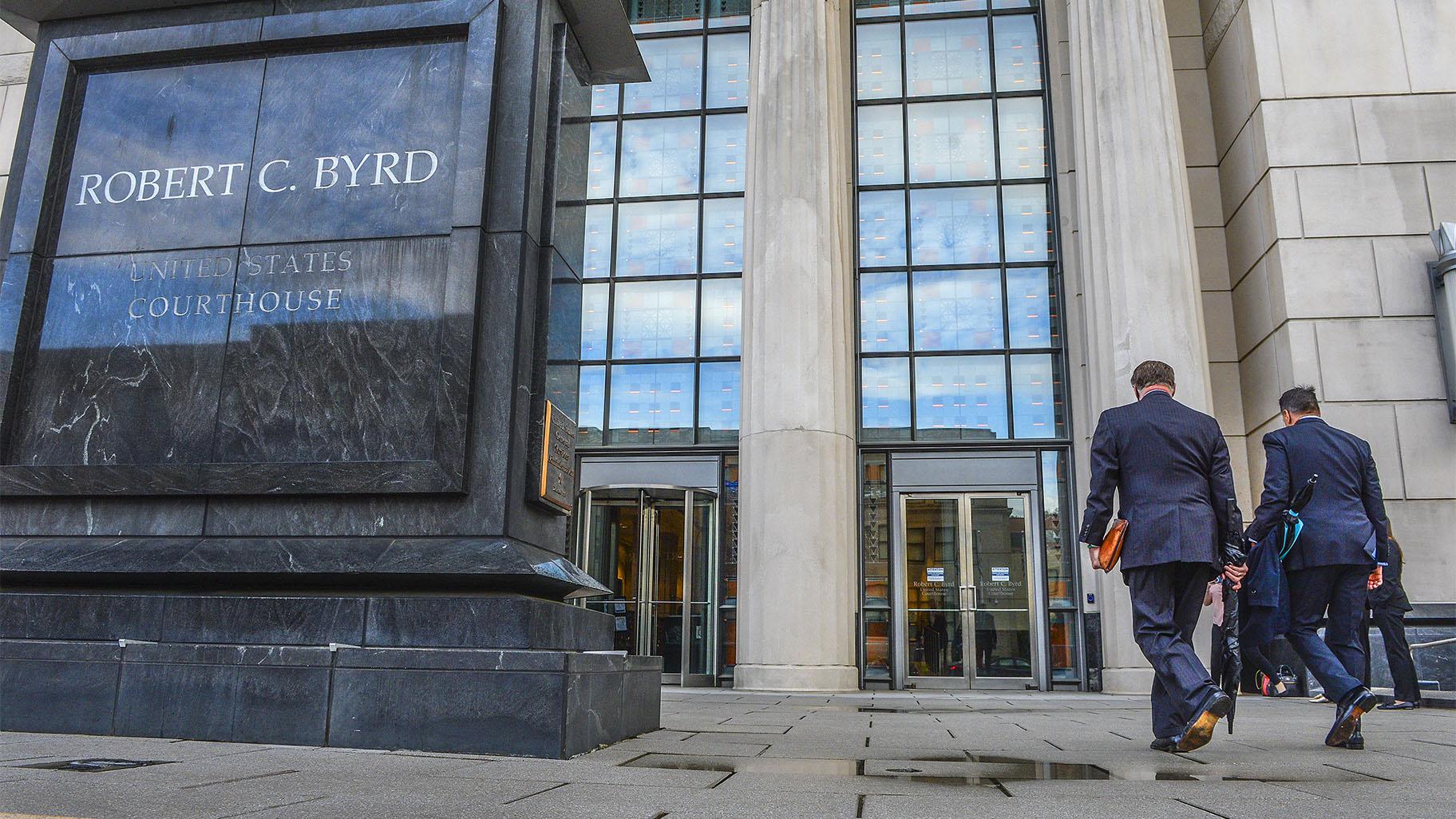 FILE - In this May 3, 2021, file photo, Huntington Mayor Steve Williams, left, and lawyer Rusty Webb enter the Robert C. Byrd United States Courthouse in Charleston, W. Va., for the start of the opioid trial. (Kenny Kemp / Charleston Gazette-Mail via AP, File)