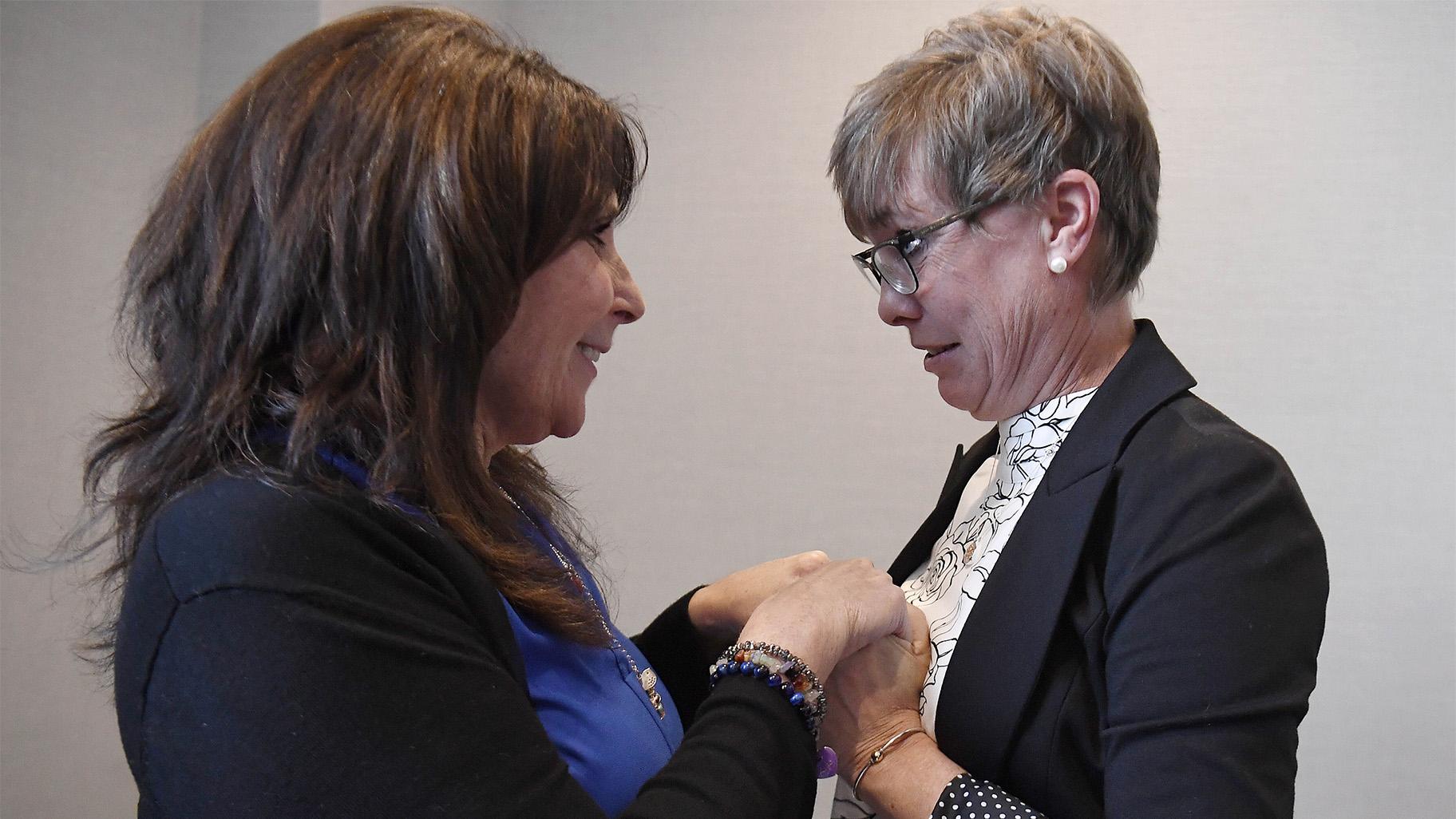 Liz Fitzgerald of Southington and Paige Niver of Manchester hold hands at the end of a news conference at Connecticut Attorney General William Tong's office, Thursday, March 3, 2022, in Hartford, Conn. Fitzgerald lost two sons to opioids and Niver's daughter became addicted to opioids after getting prescribed OxyContin at 14 years old. (AP Photo / Jessica Hill)