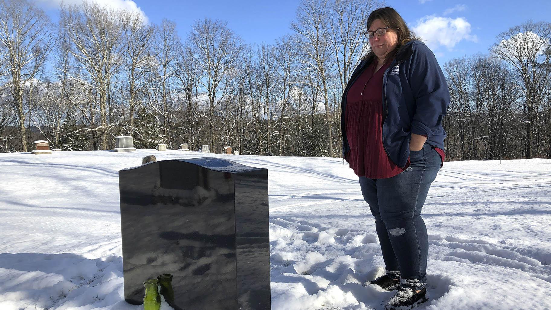 Deb Walker visits the grave of her daughter, Brooke Goodwin, Thursday, Dec. 9, 2021, in Chester, Vt. Goodwin, 23, died in March of 2021 of a fatal overdose of the powerful opioid fentanyl and xylazine, an animal tranquilizer that is making its way into the illicit drug supply. (AP Photo / Lisa Rathke, File)