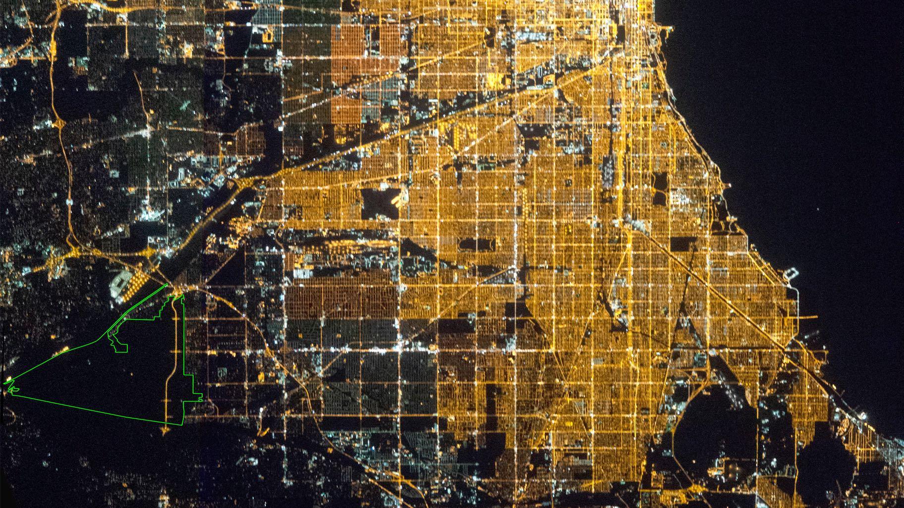 Chicago as seen from the International Space Station. The Palos Preserves Urban Night Sky Place is outlined in green. (Courtesy of the Earth Science and Remote Sensing Unit, NASA Johnson Space Center)