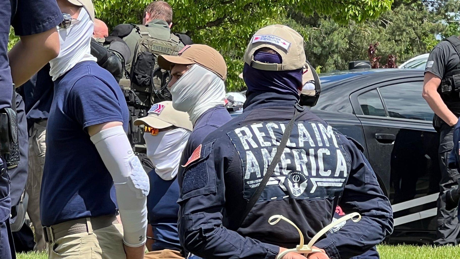 Authorities arrest members of the white supremacist group Patriot Front near an Idaho pride event Saturday, June 11, 2022, after they were found packed into the back of a U-Haul truck with riot gear. (Georji Brown via AP)