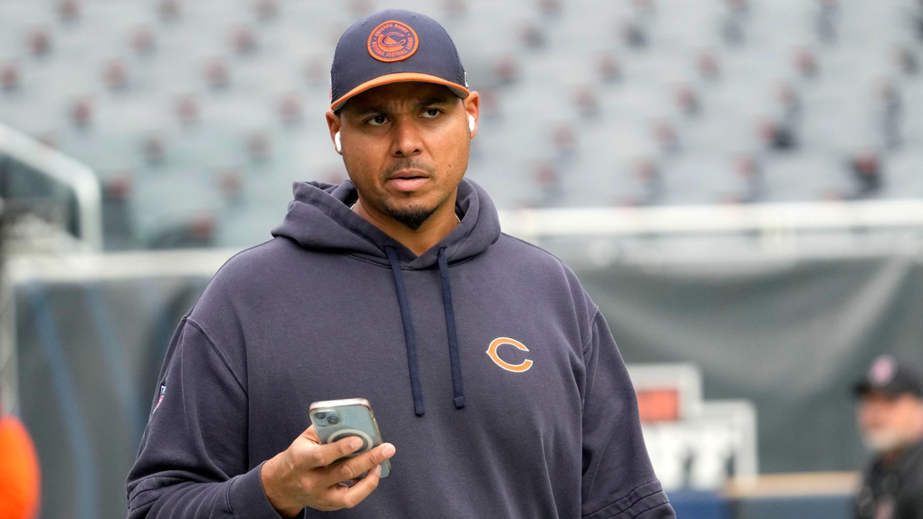 Chicago Bears General Manager Ryan Poles looks up from his cellphone as he walks the field before an NFL football game against the New England Patriots on Sunday, Nov. 10, 2024, in Chicago. (Nam Y. Huh / AP Photo)