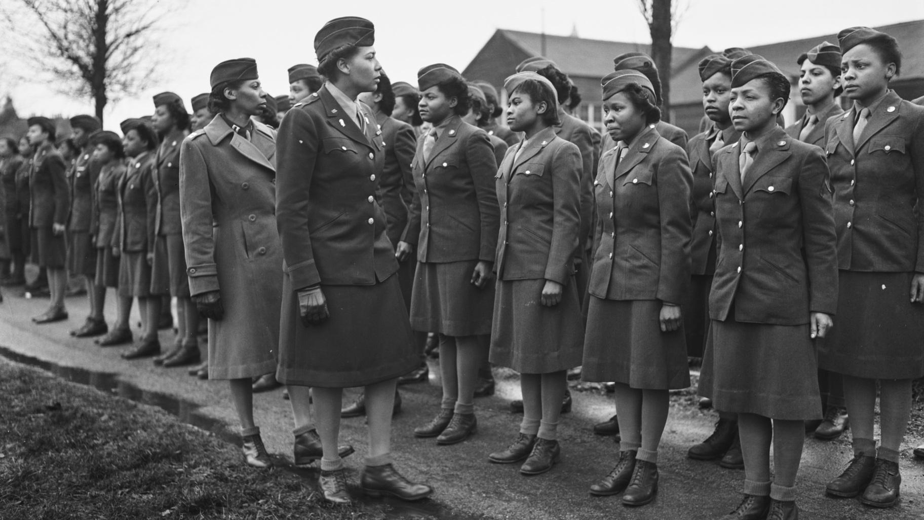 In this photo provided by the National Archives, Maj. Charity E. Adams and Capt. Mary Kearney, of the 6888th Central Postal Directory Battalion, inspect the first contingent of Black members of the Women's Army Corps assigned to overseas service in England on Feb. 15, 1945. (Holt / U.S. Army via AP)