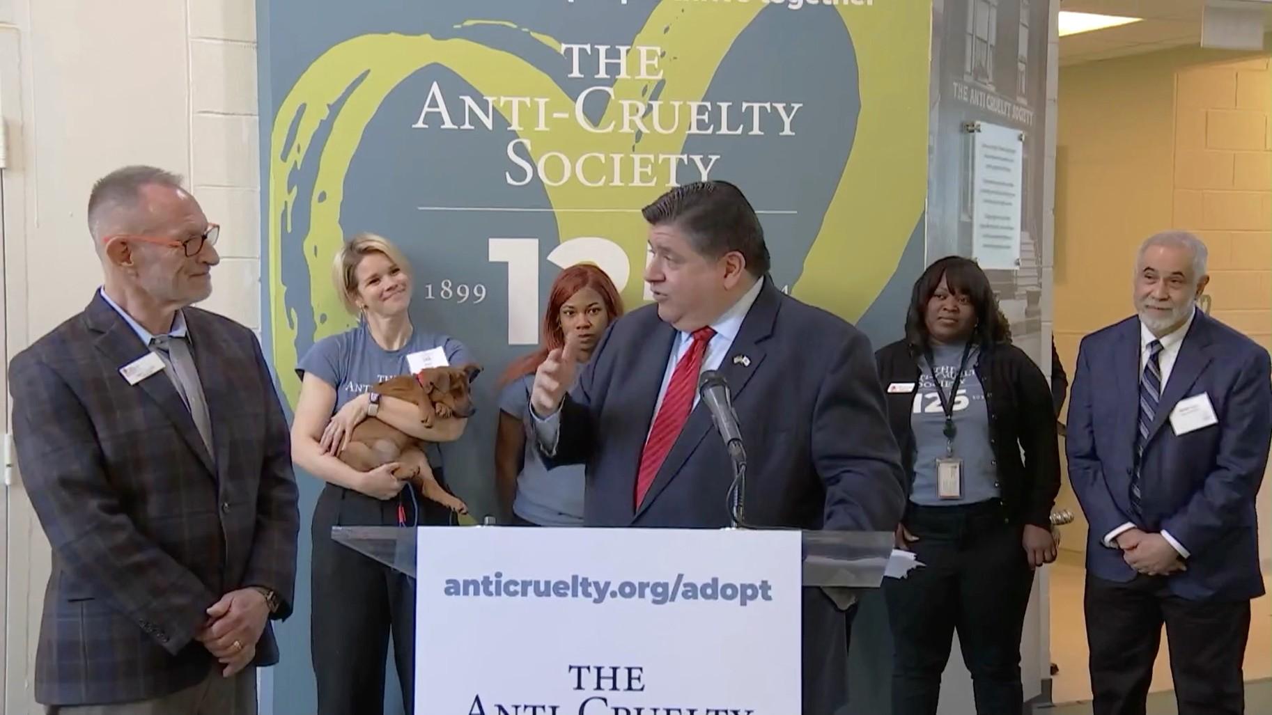Governor J.B. Pritzker speaks with Anti-Cruelty Society CEO Tracy Elliott during a press conference at the shelter located in River North on Dec. 13, 2023. (WTTW News)