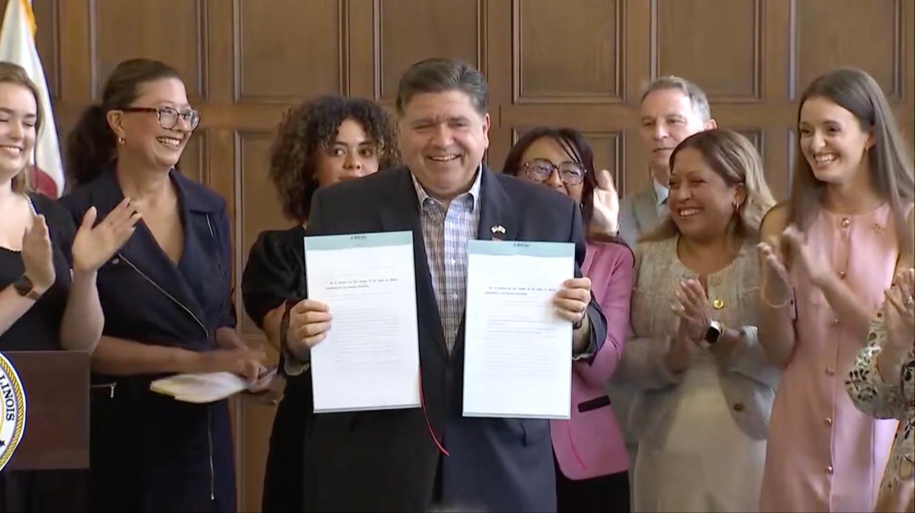 Gov. JB Pritzker signs bills aimed at further protecting reproductive rights in Illinois, on Aug 22, 2025, at the University YMCA in Champaign, Illinois. (Courtesy of State of Illinois live stream)