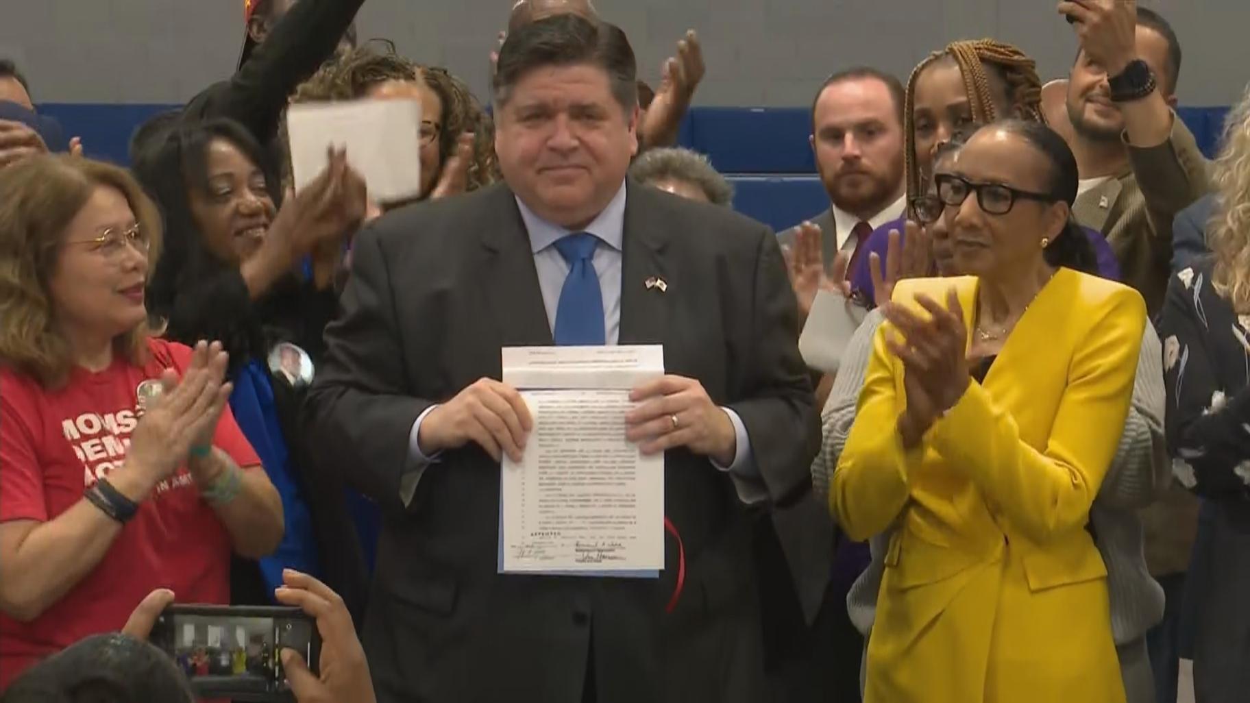 Gov. J.B. Pritzker holds a signing event for ghost gun legislation at the Ark of St. Sabina on May 18, 2022. (WTTW News)
