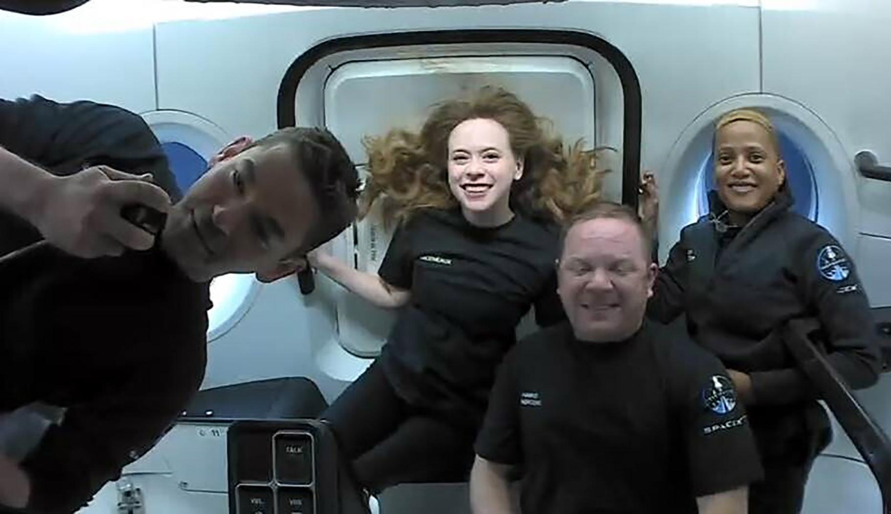 This photo provided by SpaceX shows the passengers of Inspiration4 in the Dragon capsule on their first day in space. They are, from left, Jared Isaacman, Hayley Arceneaux, Chris Sembroski and Sian Proctor. (SpaceX via AP)