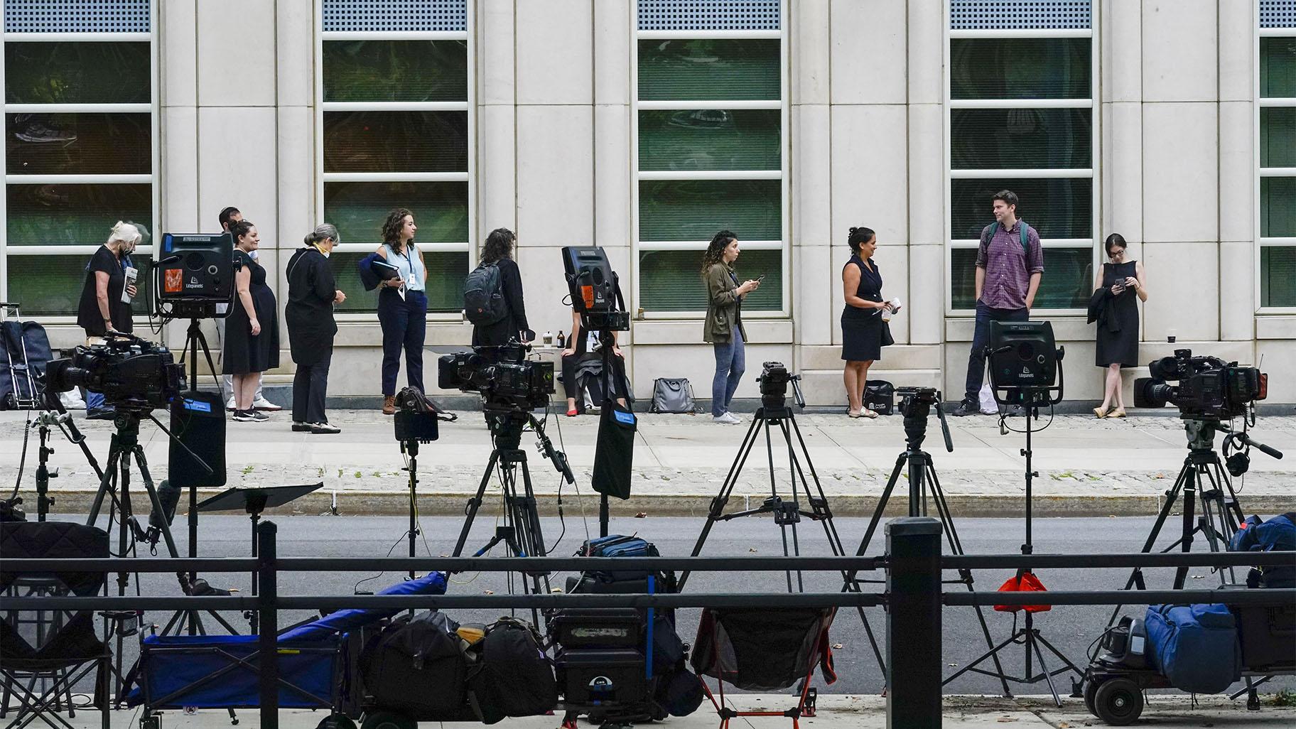 Television crew equipment is set up across the street as reporters and spectators line up outside Brooklyn Federal court for opening statements in R&B star R. Kelly's long-anticipated federal trial arising from years of allegations that he sexually abused women and girls, Wednesday, Aug. 18, 2021, in New York. (AP Photo / Mary Altaffer)