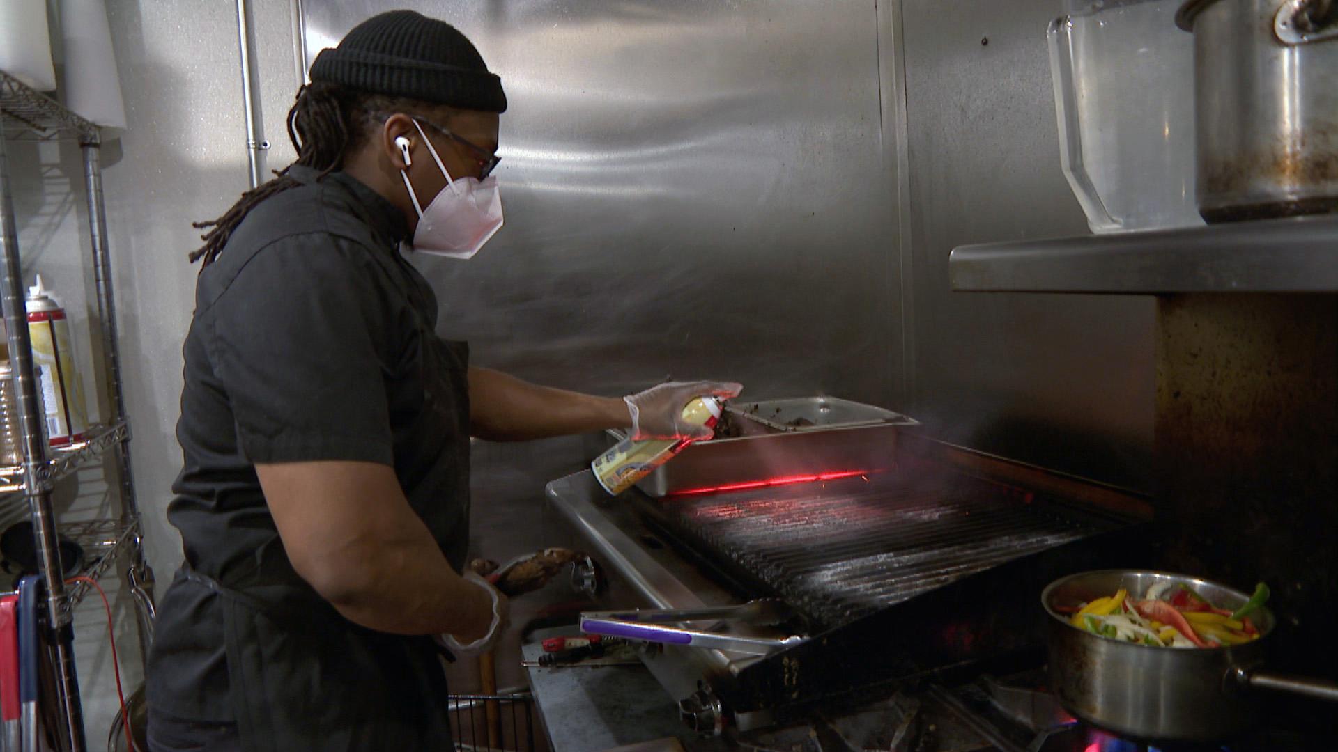 A restaurant worker in Chicago preps the grill. City officials on Friday said rules around indoor dining at bars and restaurants will largely go unchanged, for the time being, even if state-imposed restrictions are soon relaxed. (WTTW News)