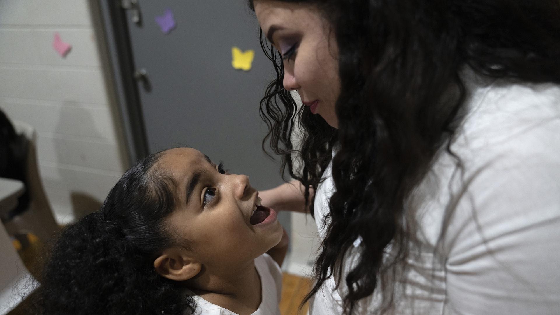 Myla Martinez, 6-year-old, enthusiastically greets her mother Crystal Martinez as she and her four younger siblings spend time her with her during a special visit at Logan Correctional Center, Saturday, May 20, 2023, in Lincoln, Illinois. (AP Photo/Erin Hooley)