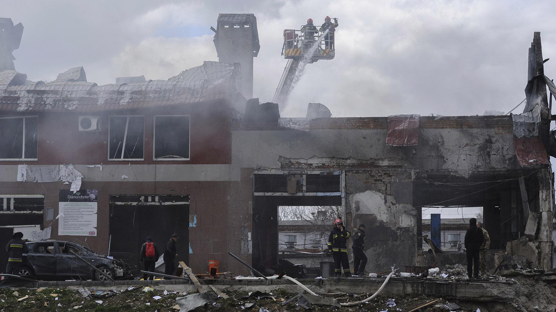 Firefighters work to extinguish a fire after an airstrike hit a tire shop in Lviv, Ukraine, Monday, April 18, 2022. (AP Photo / Mykola Tys)