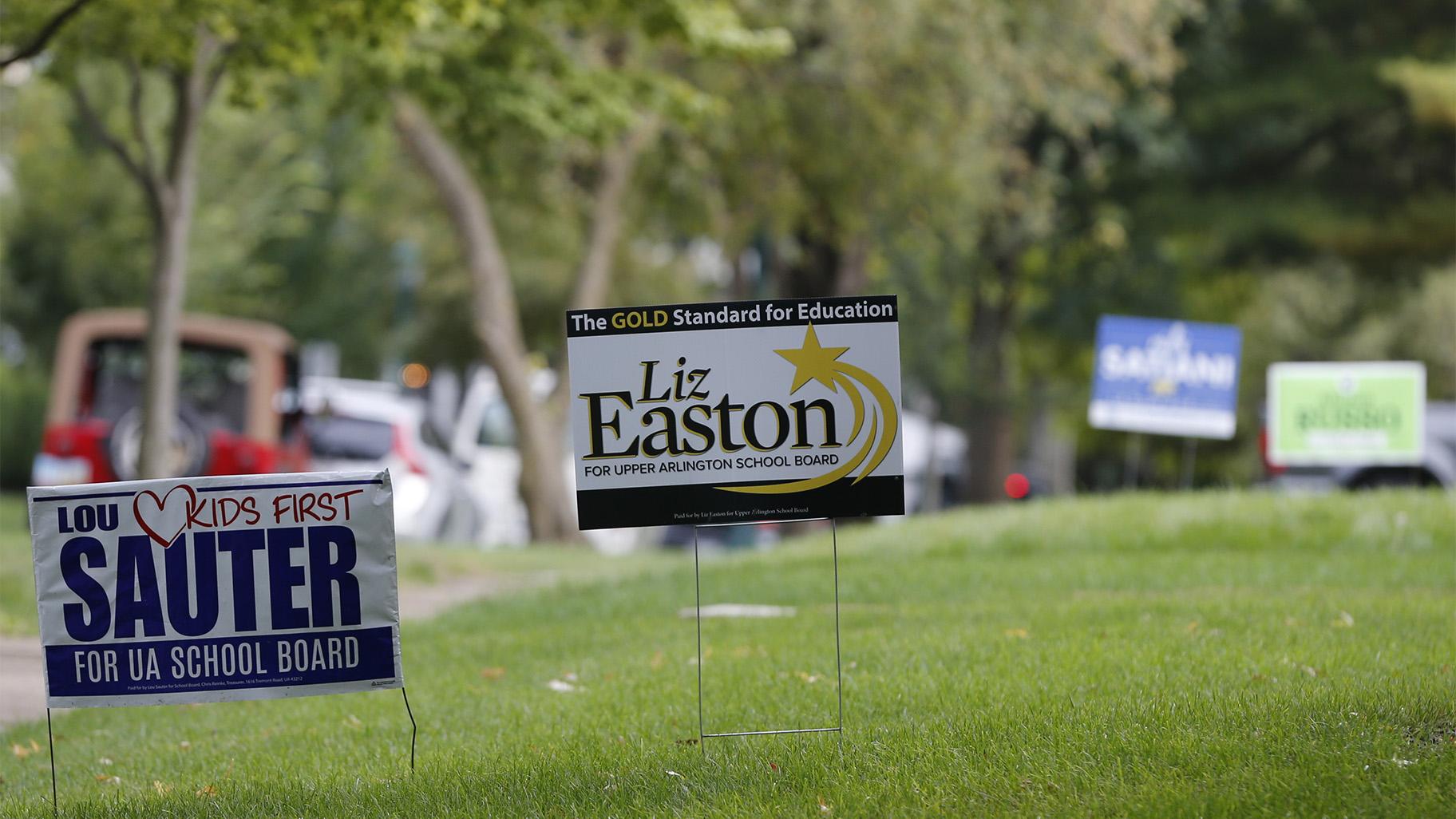 Campaign yard signs line a street Thursday, Oct. 7, 2021, in Upper Arlington, Ohio. (AP Photo / Jay LaPrete)