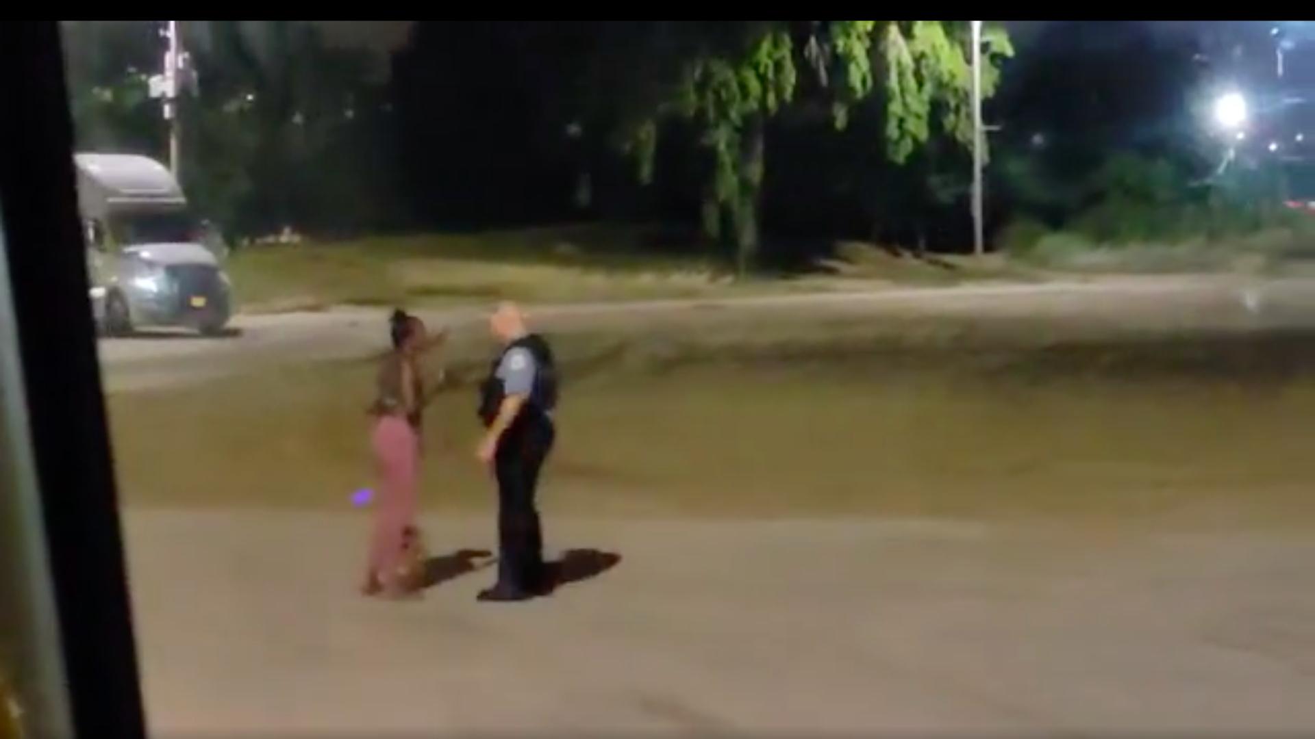 A still image from a video provided to WTTW News shows Nikkita Brown and a Chicago police officer in North Avenue Beach around 12:12 a.m. on Saturday, August 28, 2021. (Courtesy Saulter Law PC)