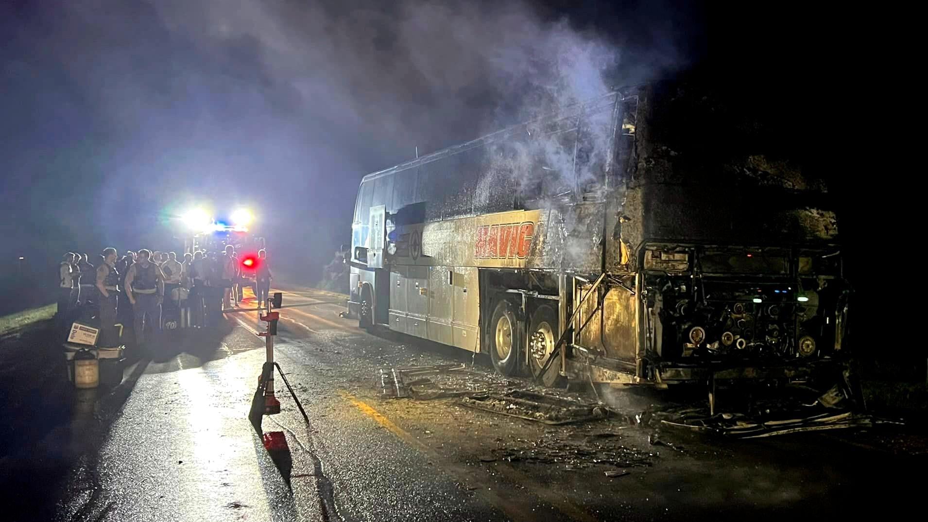 In this photo provided by J.D. Scholten, a bus carrying the Sioux City Explorers to a baseball game in Illinois caught fire early on Friday, Aug. 2, 2024, near Earlham, Iowa. State Rep. J.D. Scholten, who is a pitcher for the team, wrote in a Facebook post that he was grateful no one was hurt. (J.D. Scholten via AP)