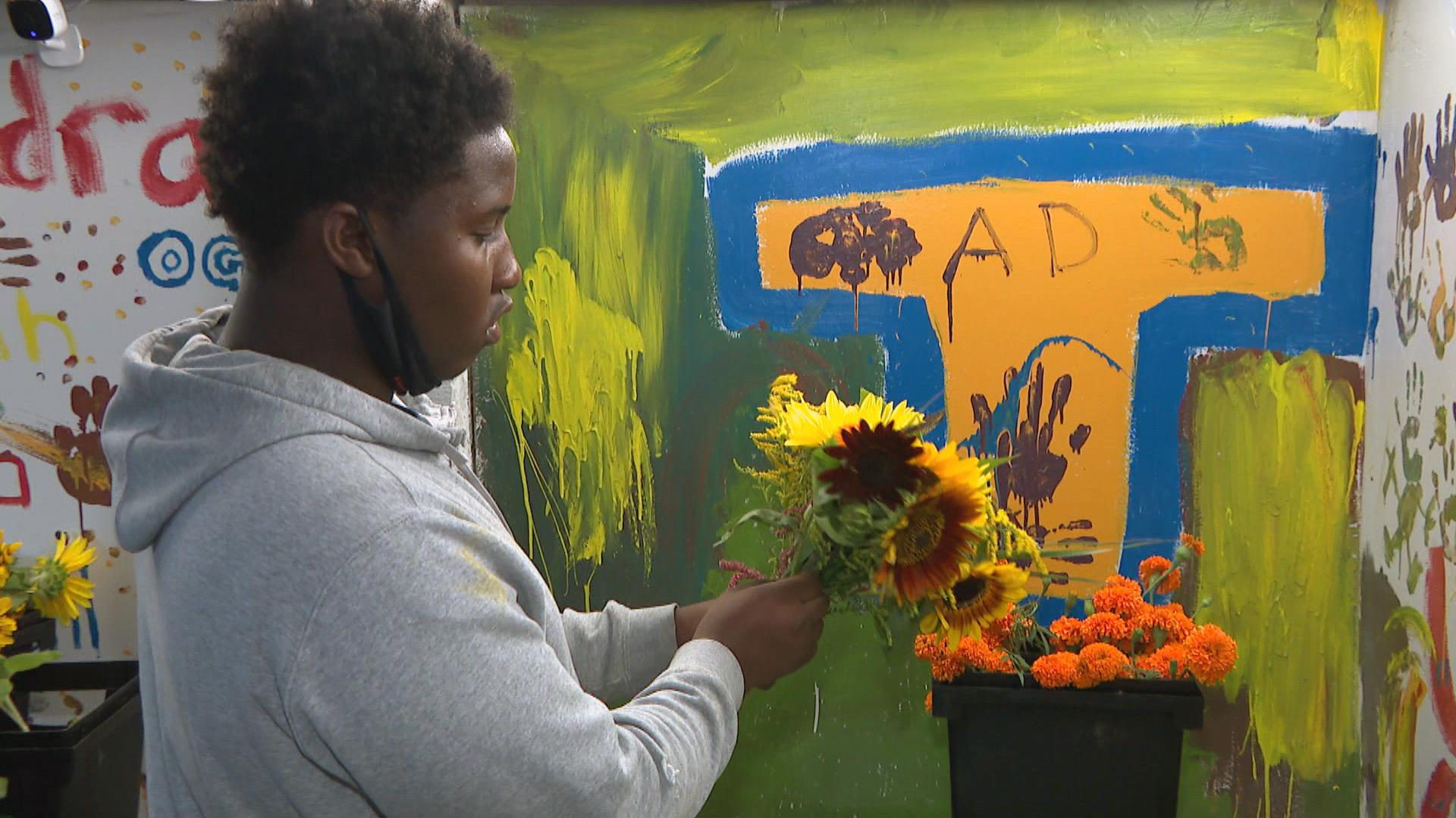A young flower farmer creates a bouquet at Southside Blooms. (WTTW News)