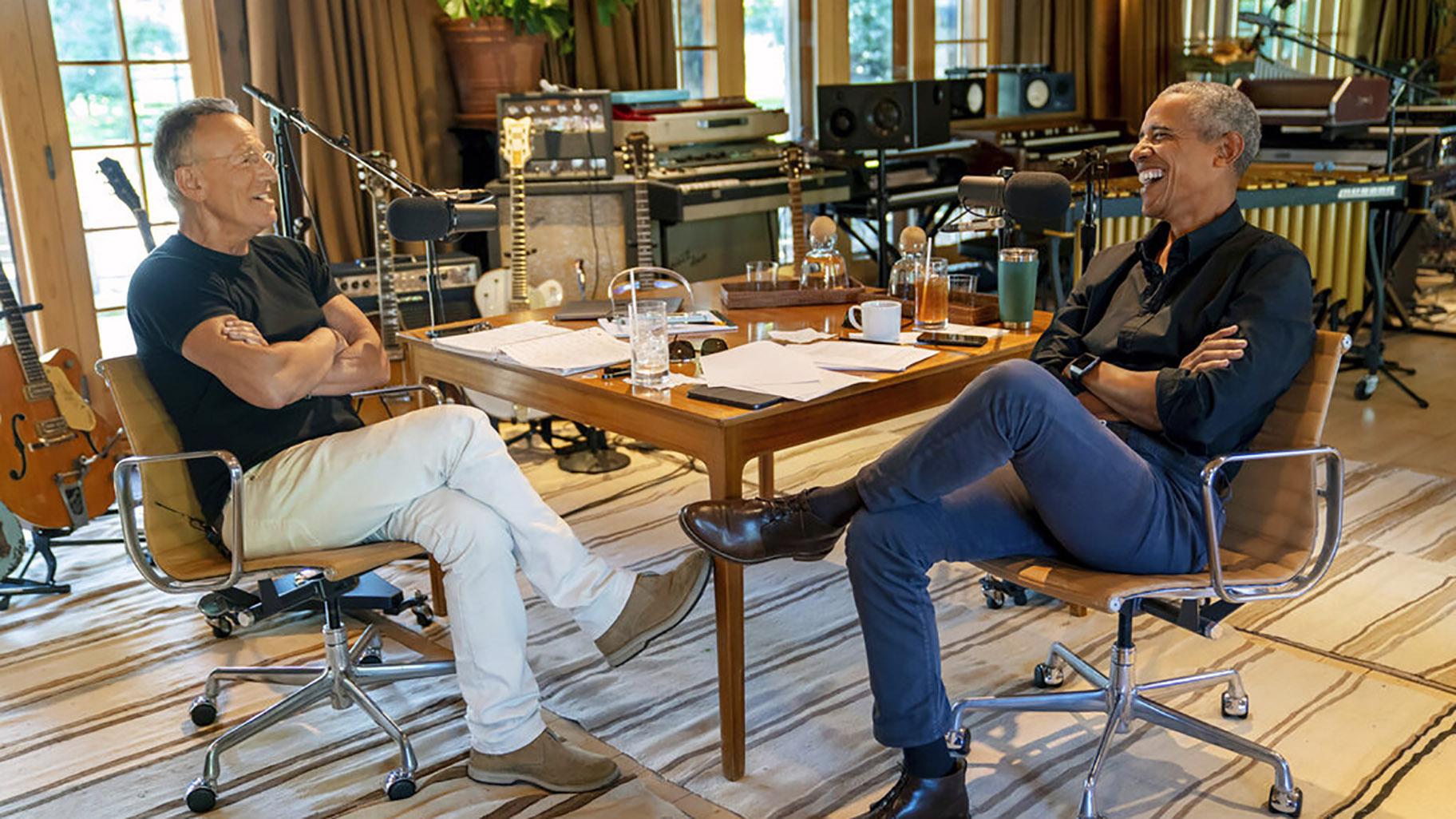Bruce Springsteen, left, appears with former President Barack Obama during their podcast of conversations recorded at Springsteen's home studio in New Jersey. The eight-episode series covers their upbringings, racism, fatherhood and even recall a White House singalong around a piano. (Rob DeMartin / Spotify via AP)