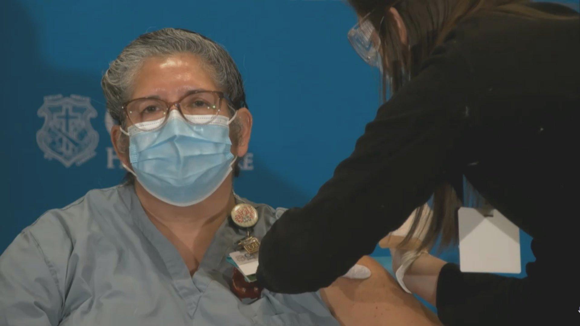 A health care worker gets the COVID-19 vaccine in Peoria, Illinois on Tuesday, Dec. 15, 2020. (WTTW News)