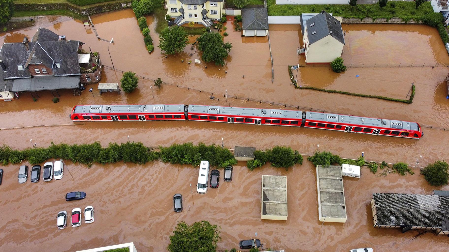In this Thursday, July 15, 2021, 2021 file photo, a regional train in the flood waters at the local station in Kordel, Germany, after it was flooded by the high waters of the Kyll river. (Sebastian Schmitt / dpa via AP, File)