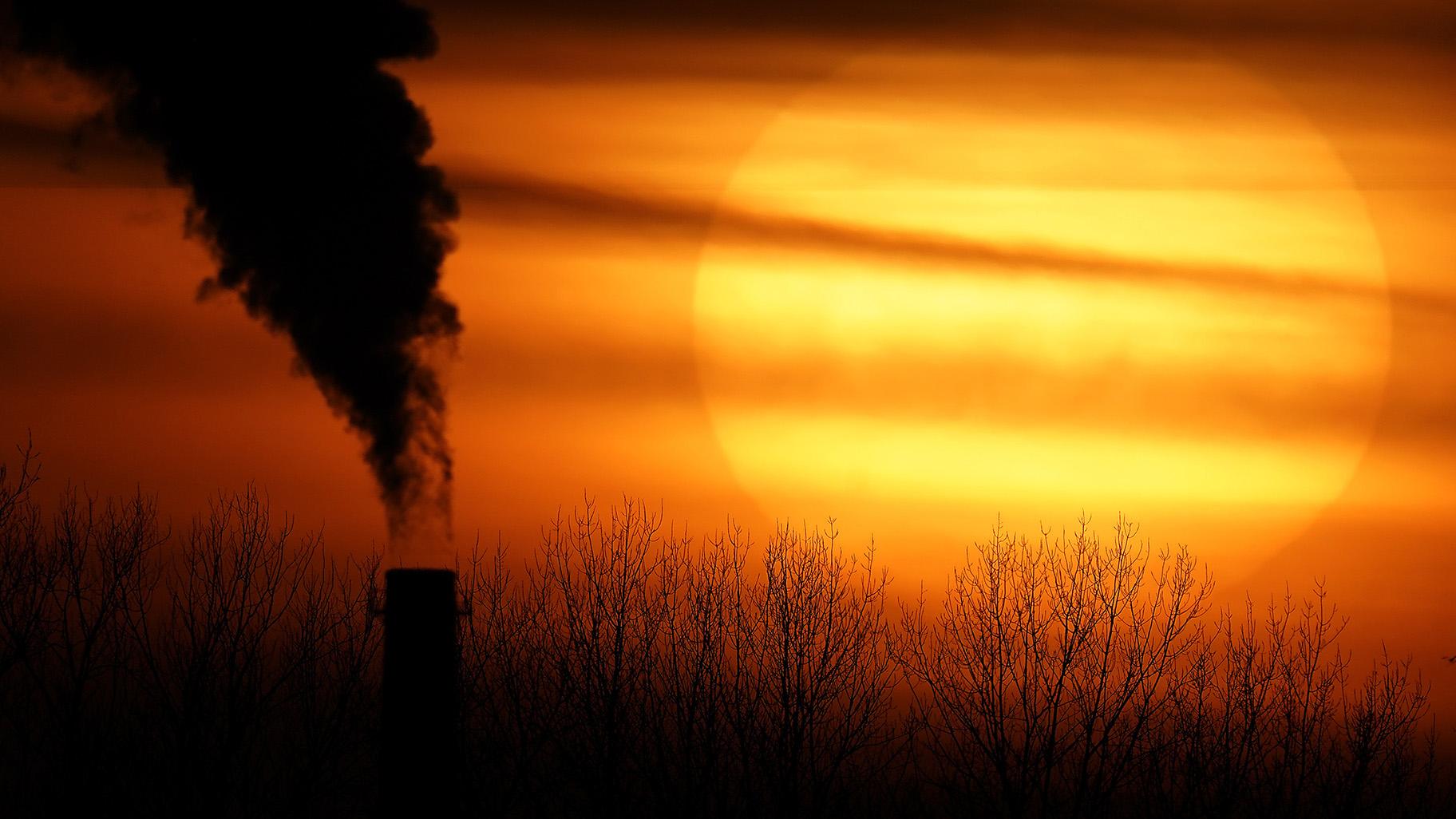  Emissions from a coal-fired power plant are silhouetted against the setting sun in Kansas City, Mo., Feb. 1, 2021. (AP Photo / Charlie Riedel, File)
