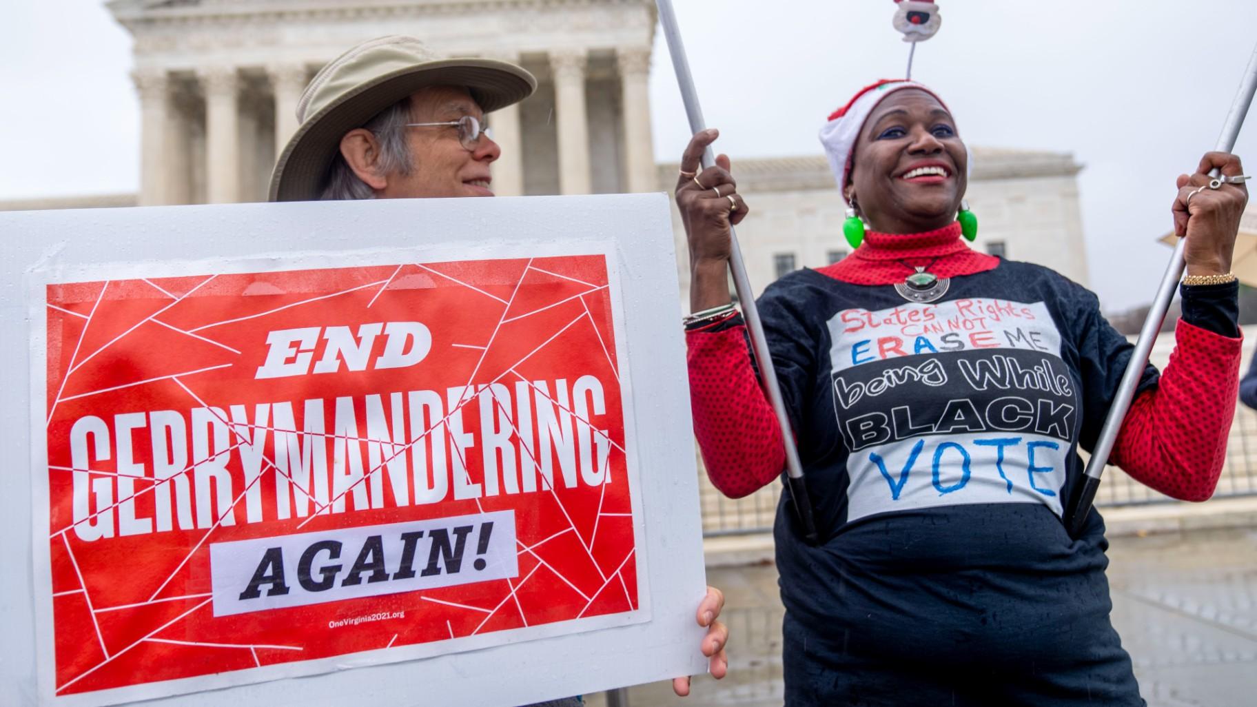 Michael Martin of Springfield, Va., with UpVote Virginia, holds a sign that reads “End Gerrymandering Again!” and speaks with Nadine Seiler of Waldorf, Md., in front of the Supreme Court in Washington, Wednesday, Dec. 7, 2022. (AP Photo / Andrew Harnik)