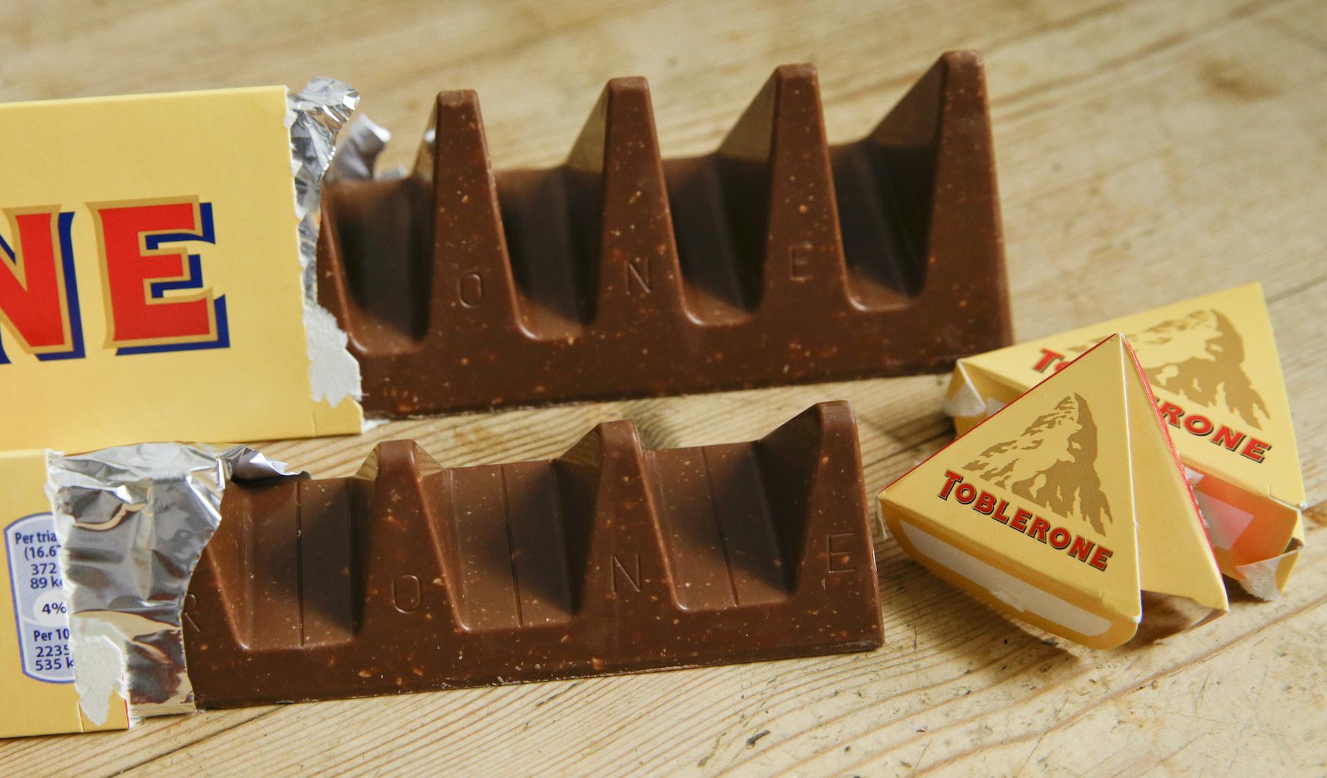 Two bars of the Toblerone Swiss chocolate are shown, at front is the new style 150 gram bar showing the reduction in triangular pieces, in the background is the older style 360 gram bar, pictured in London, on Nov. 8, 2016. (AP Photo/Alastair Grant, File)