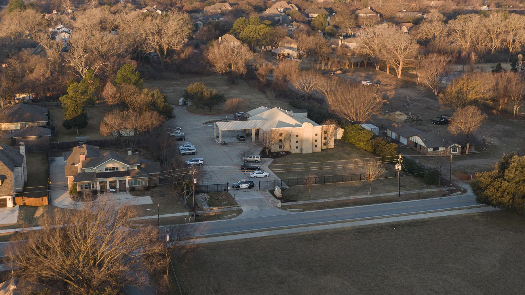 An aerial view of police standing in front of the Congregation Beth Israel synagogue, Sunday, Jan. 16, 2022, in Colleyville, Texas. A man held hostages for more than 10 hours Saturday inside the temple. (AP Photo / Brandon Wade)