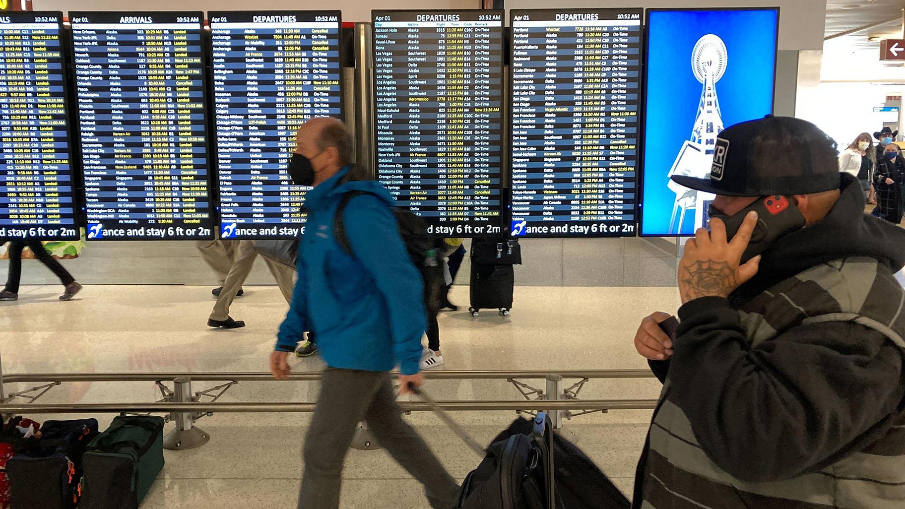 Travelers walk through Seattle-Tacoma International Airport on Friday, April 1, 2022 in Seattle. (AP Photo / Ted S. Warren, File)