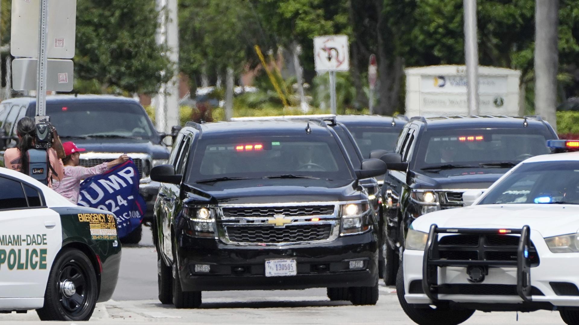 Former President Donald Trump arrives at his Trump National Doral resort Monday, June 12, 2023, in Doral, Fla., as a supporter looks on. (AP Photo/Jim Rassol)