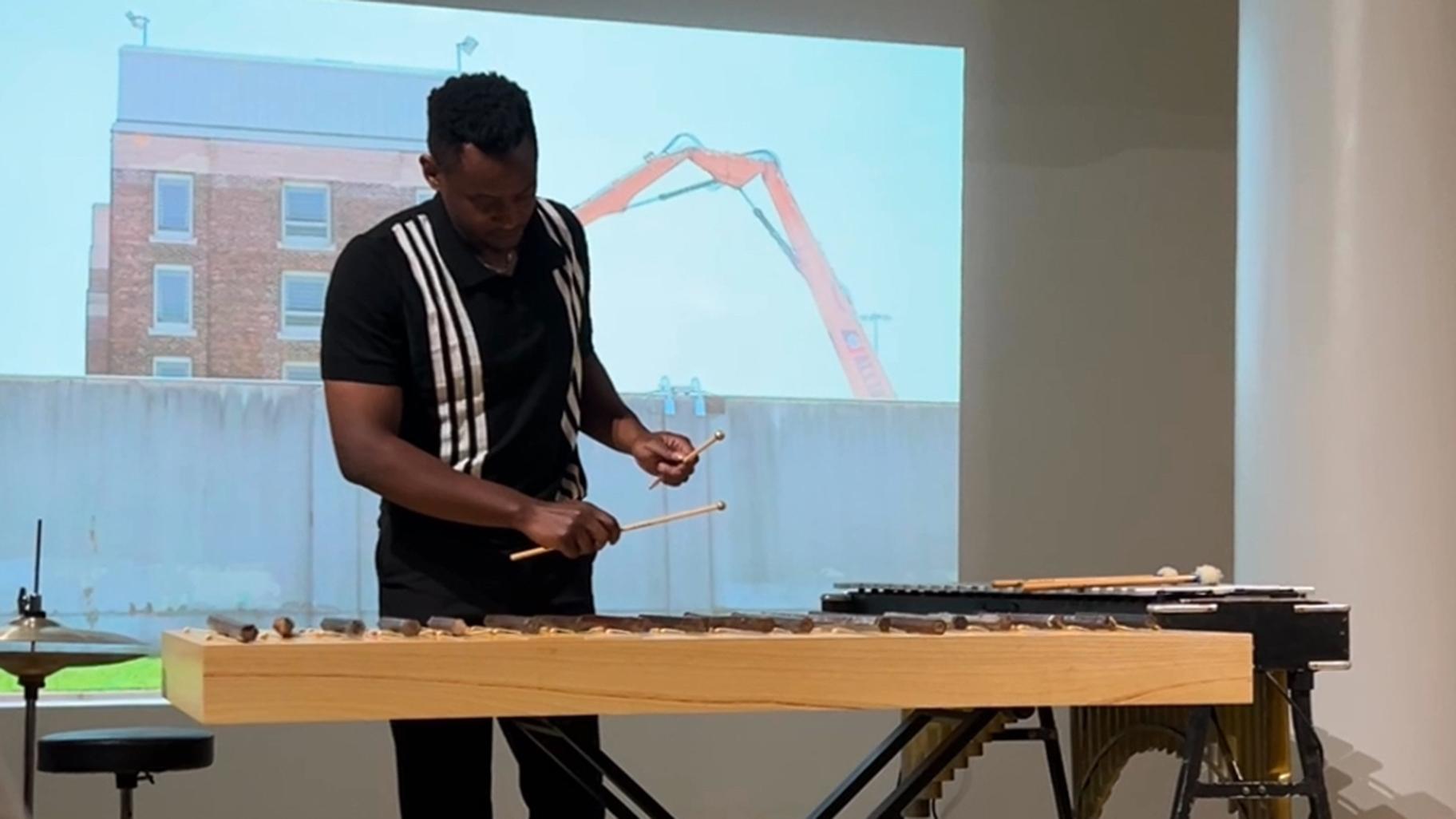 Vibraphonist Thaddeus Tukes plays a “sonic sculpture” crafted out of cell bars from Cook County Jail, part of the performance “We Lit the Fire and Trusted the Heat (after Angela Davis).” (Blair Paddock / WTTW News)