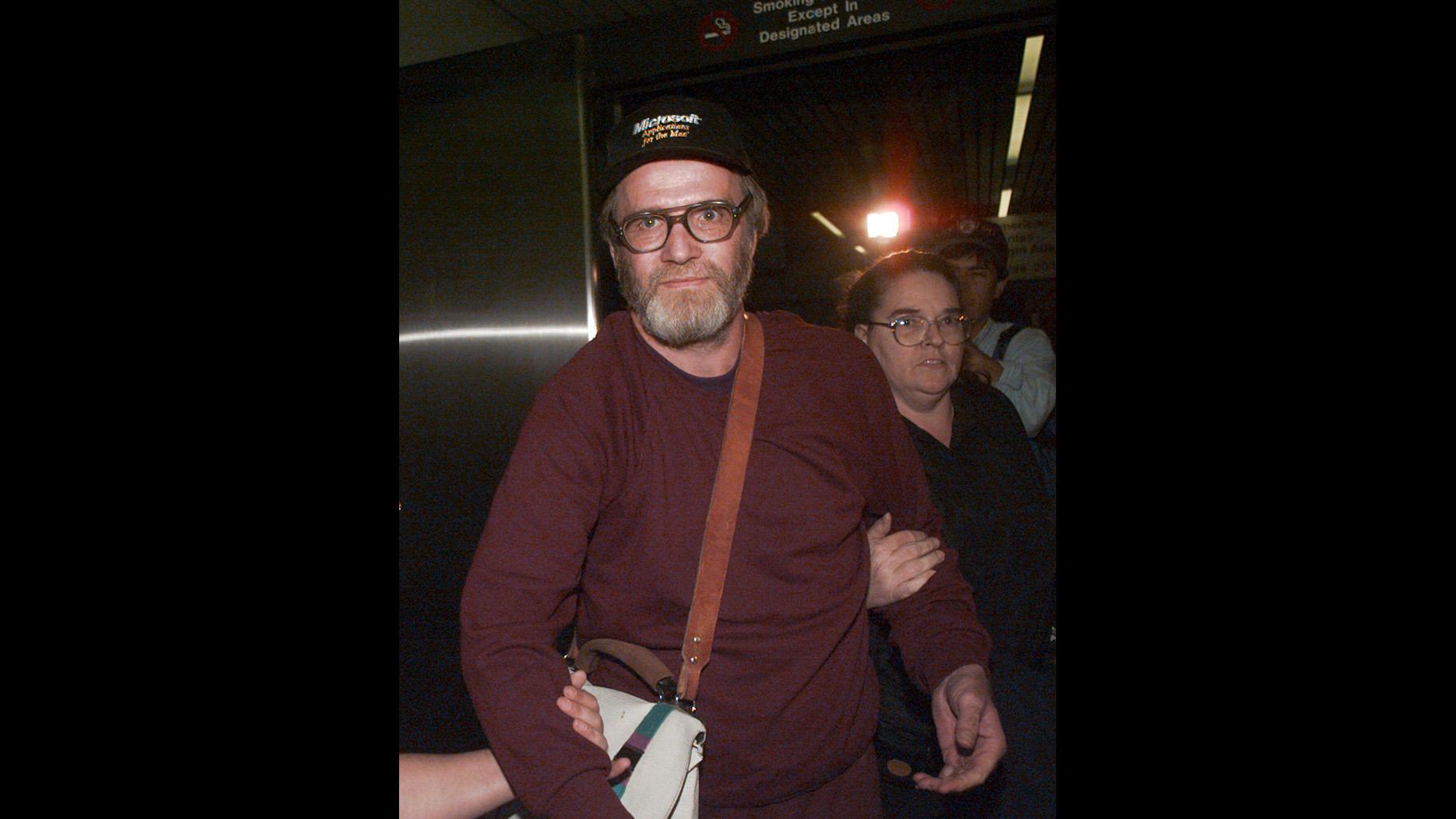  James Lewis is escorted through Boston's Logan Airport, Friday Oct. 13, 1995, after being released from the Federal Correctional Institution in Oklahoma.  (AP Photo / Charles Krupa, File)