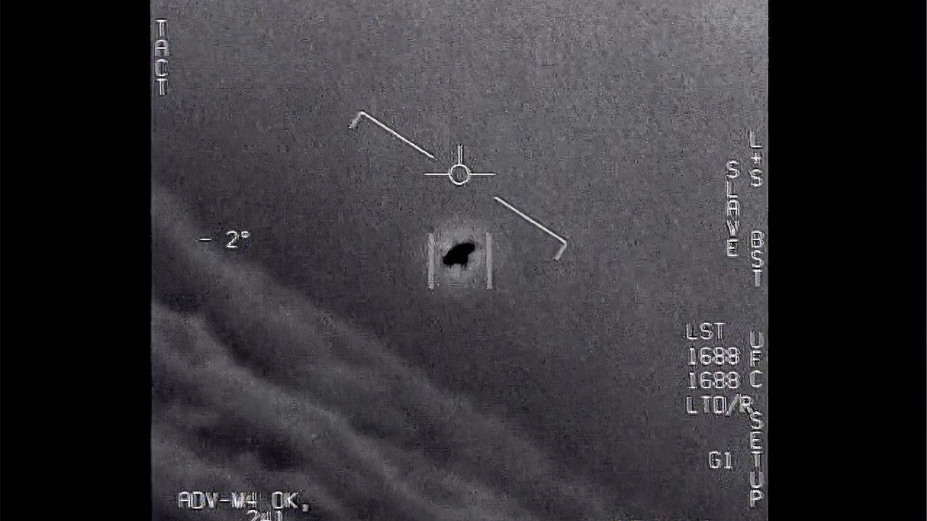 The image from video provided by the Department of Defense labelled Gimbal, from 2015, an unexplained object is seen at center as it is tracked as it soars high along the clouds, traveling against the wind. (Department of Defense via AP)