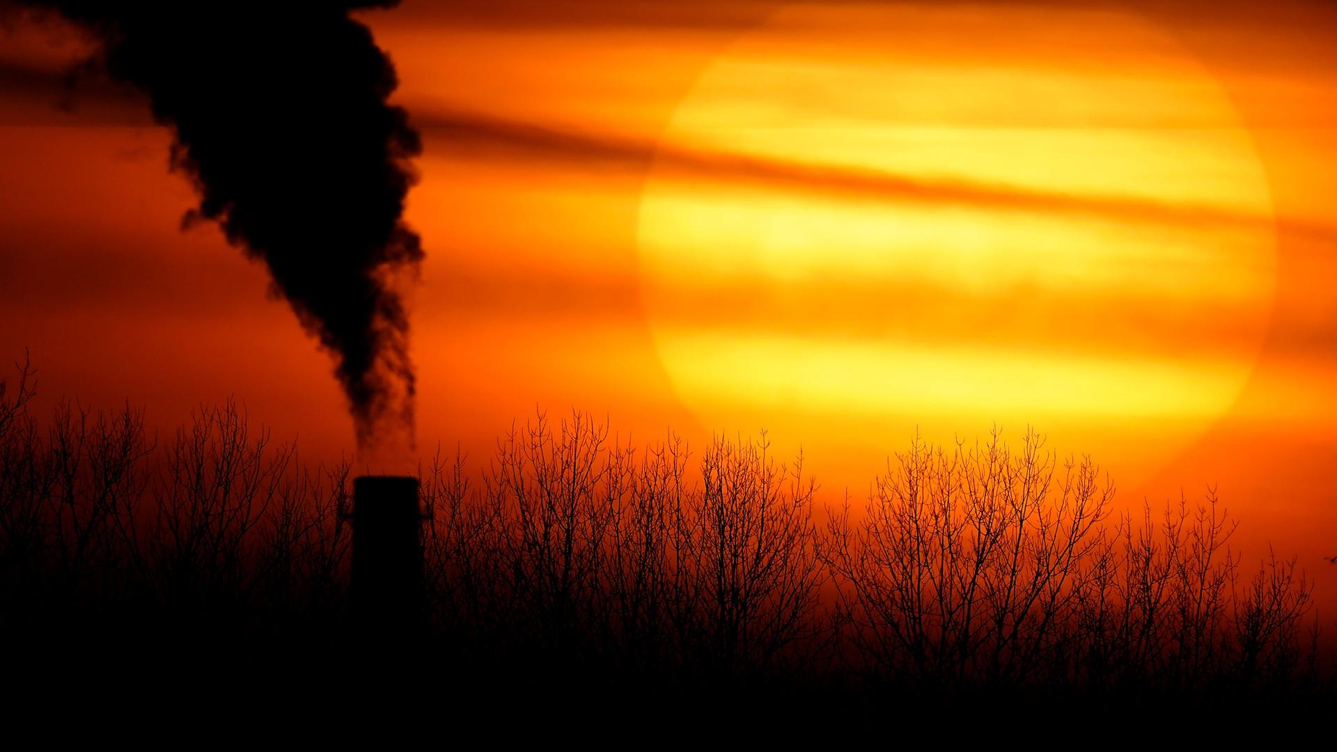 In this Monday, Feb. 1, 2021 file photo, emissions from a coal-fired power plant are silhouetted against the setting sun in Independence, Mo. (AP Photo / Charlie Riedel)
