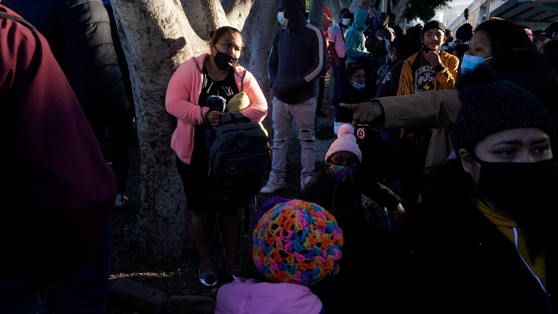 In this Feb. 19, 2021 file photo, a woman seeking asylum in the United States waits with others for news of policy changes, in Tijuana, Mexico. (AP Photo / Gregory Bull, File)