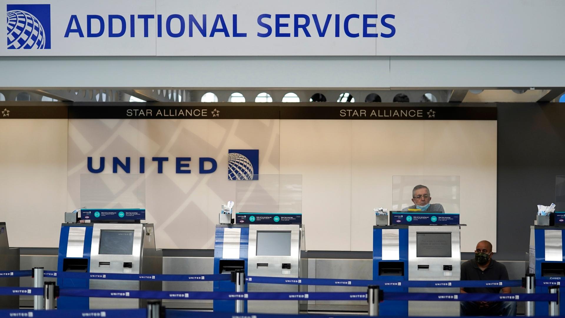 In this Oct. 14, 2020 file photo, United Airlines employees work at ticket counters in Terminal 1 at O'Hare International Airport in Chicago. (AP Photo / Nam Y. Huh, File)