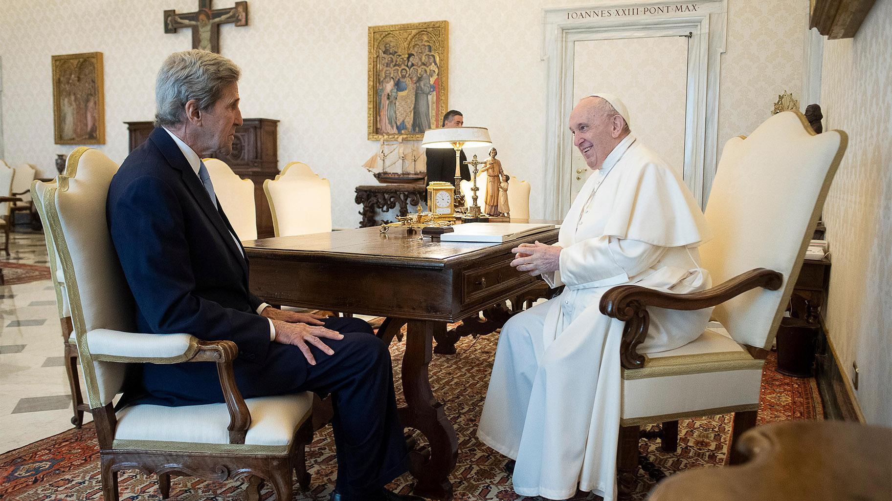 Pope Francis and John Kerry talk during their meeting at the Vatican, Saturday, May 15, 2021. (Vatican Media via AP)