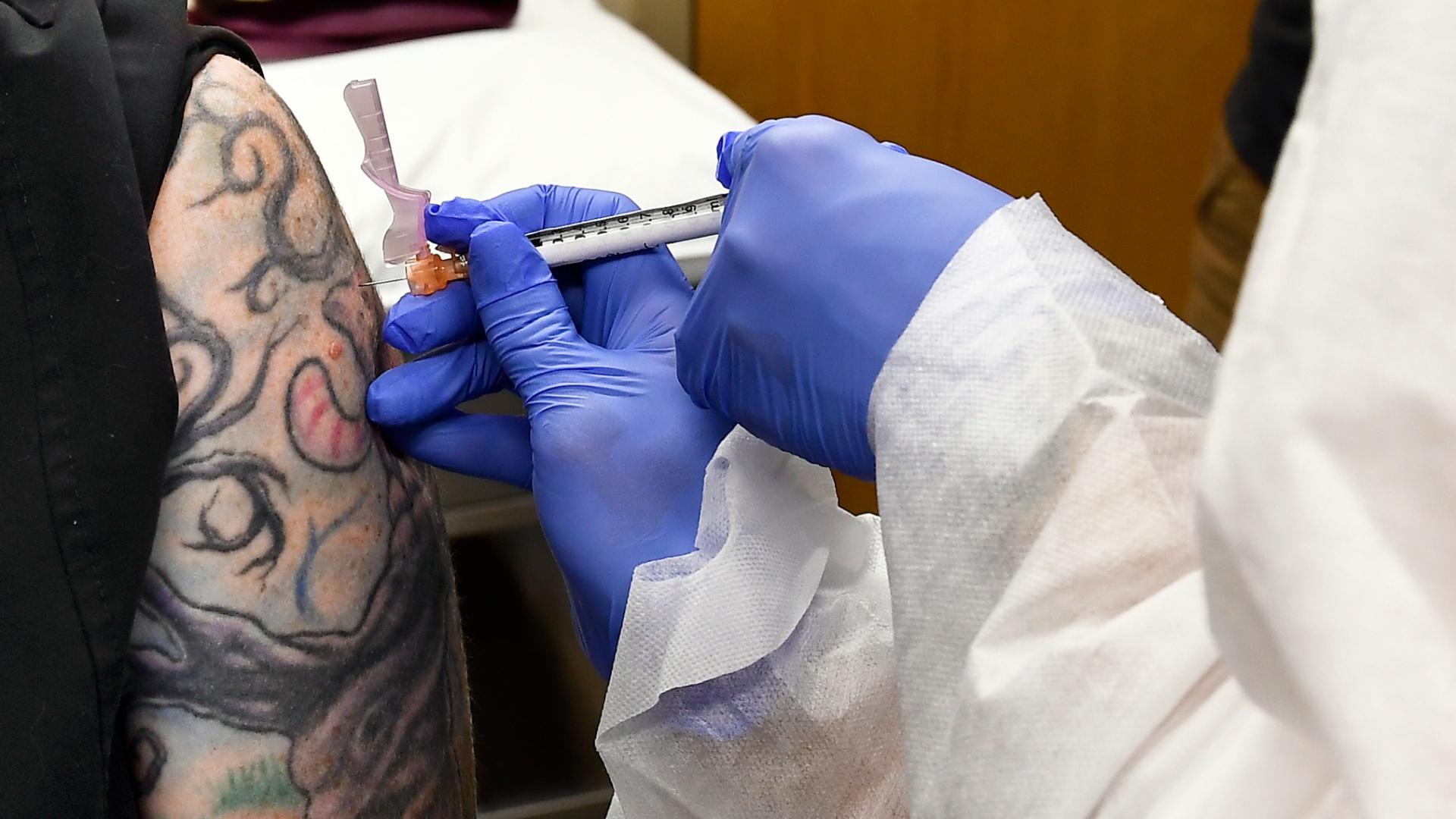 In this July 27, 2020, file photo, nurse Kathe Olmstead, right, gives volunteer Melissa Harting, of Harpersville, N.Y., an injection as a study of a possible COVID-19 vaccine, developed by the National Institutes of Health and Moderna Inc., gets underway in Binghamton, N.Y. (AP Photo / Hans Pennink, File)