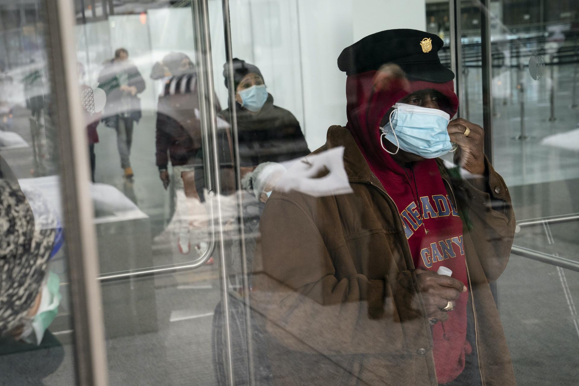 In this Feb. 3, 2021, file photo, a patient adjusts his face mask as he leaves a COVID-19 vaccination site inside the Jacob K. Javits Convention Center in New York. (AP Photo/John Minchillo, File)