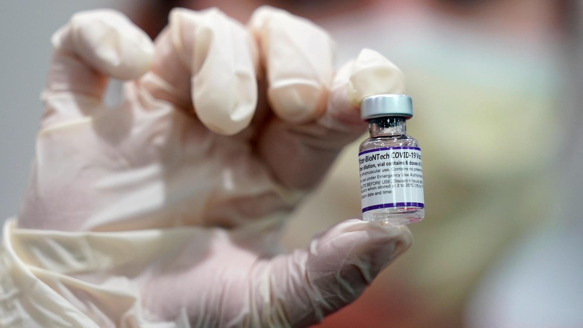 A health care worker holds a vial of the Pfizer COVID-19 vaccine at Jackson Memorial Hospital in Miami, in this Tuesday, Oct. 5, 2021, file photo. (AP Photo / Lynne Sladky, File)