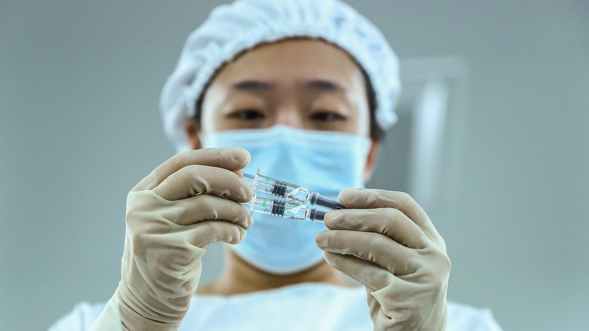 In this Dec. 25, 2020 file photo, released by Xinhua News Agency, a staff member inspects syringes of COVID-19 inactivated vaccine products at a packaging plant of the Beijing Biological Products Institute Co., Ltd, a unit of state-owned Sinopharm in Beijing. (Zhang Yuwei / Xinhua via AP, File)