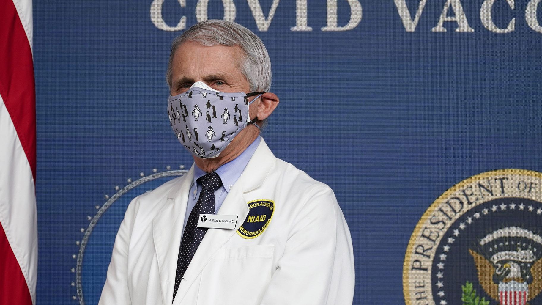 In this Feb. 25, 2021, Dr. Anthony Fauci, director of the National Institute of Allergy and Infectious Diseases, listens as President Joe Biden speaks during an event to commemorate the 50 millionth COVID-19 shot in Washington. (AP Photo / Evan Vucci, File)